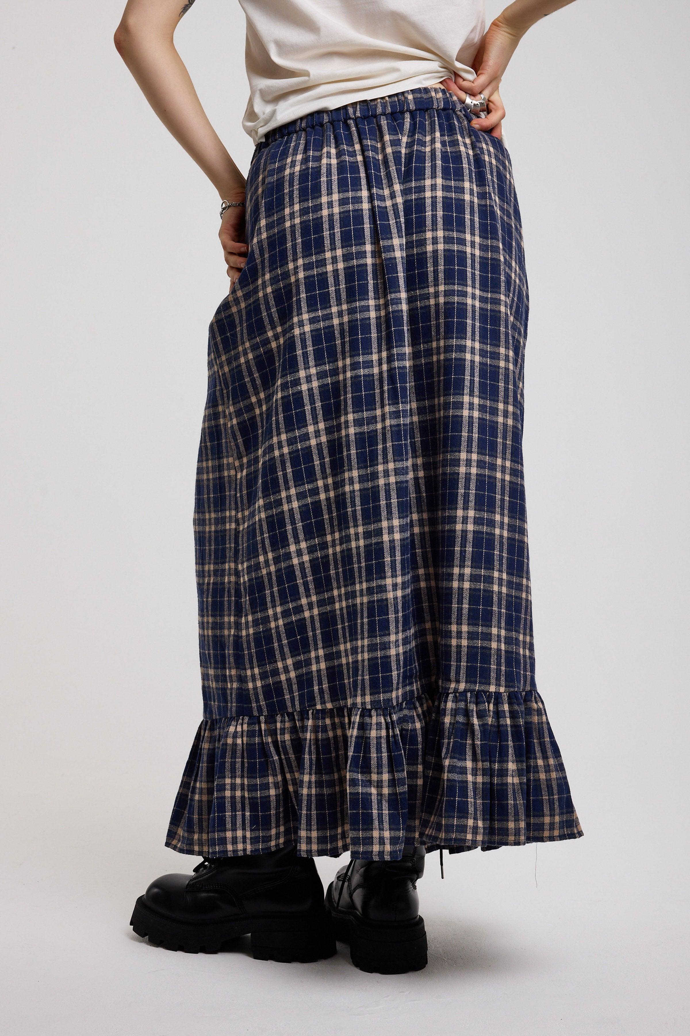 Back image of blue and yellow check maxi skirt with peplum hem, worn by model
