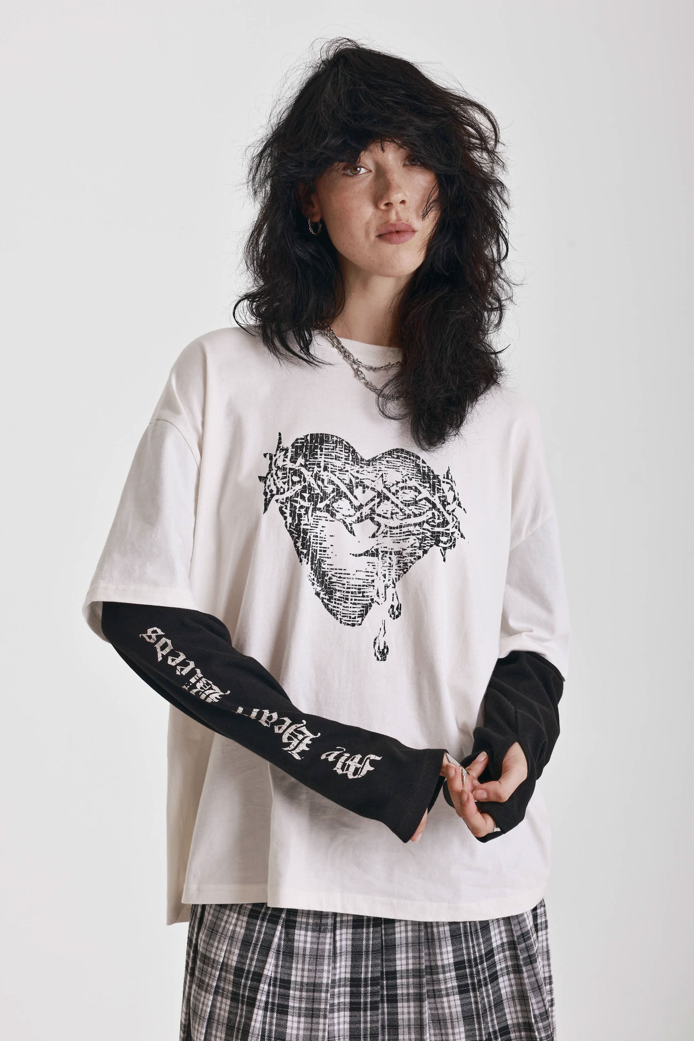 Ecru long sleeve skate t-shirt with screen printed grunge thorn heart print, worn by model