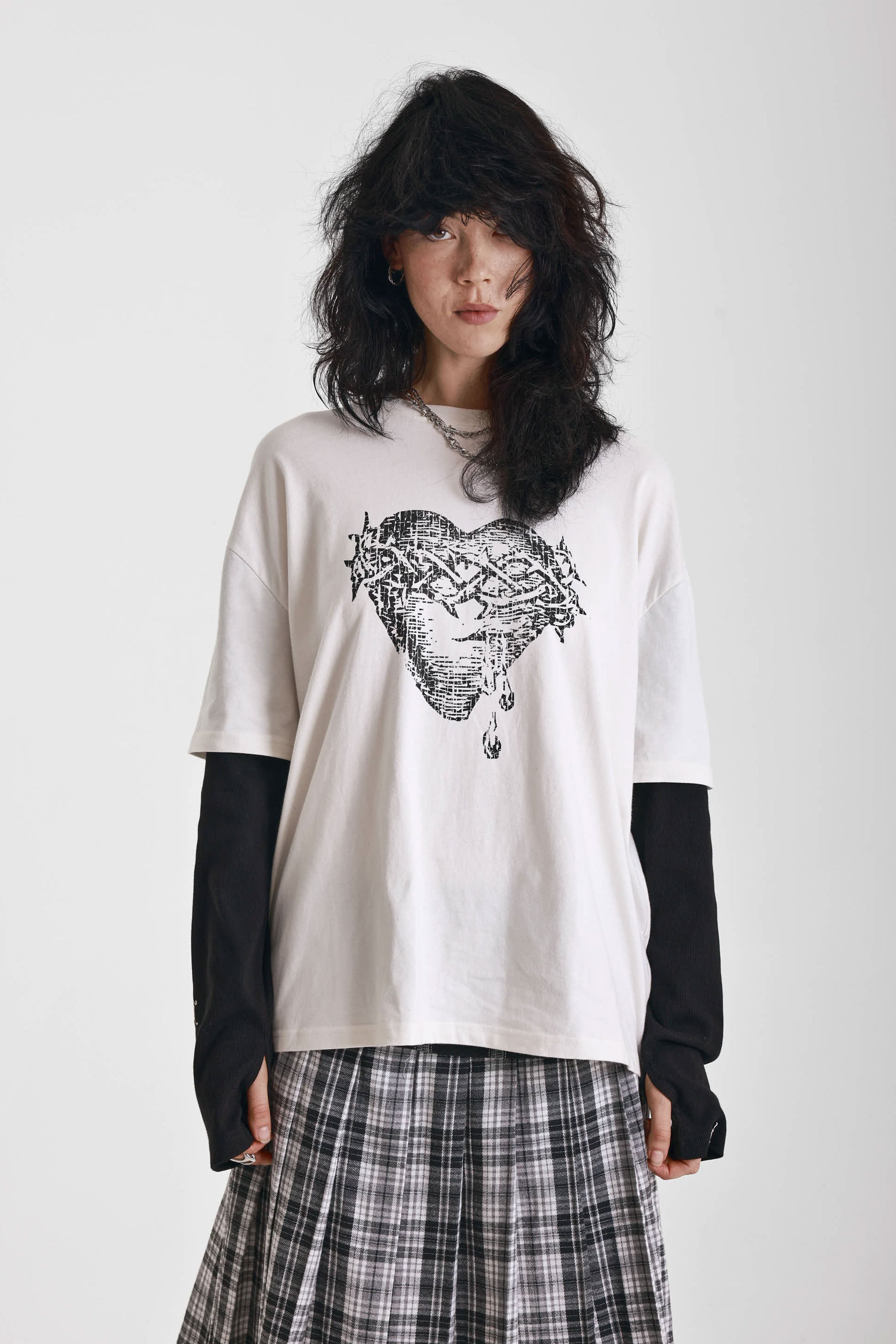 Ecru long sleeve skate t-shirt with screen printed grunge thorn heart print, worn by model