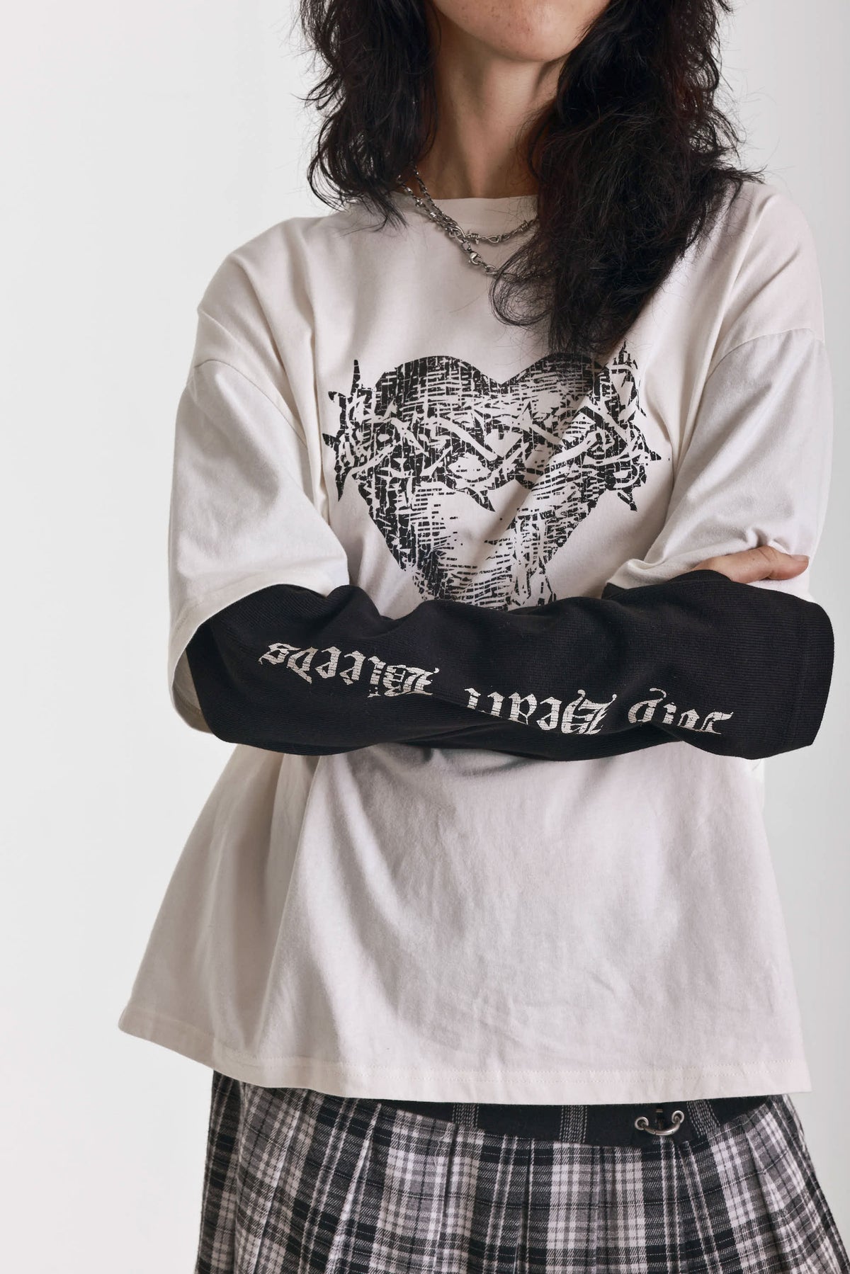 Ecru long sleeve skate t-shirt with screen printed grunge thorn heart print, worn by model