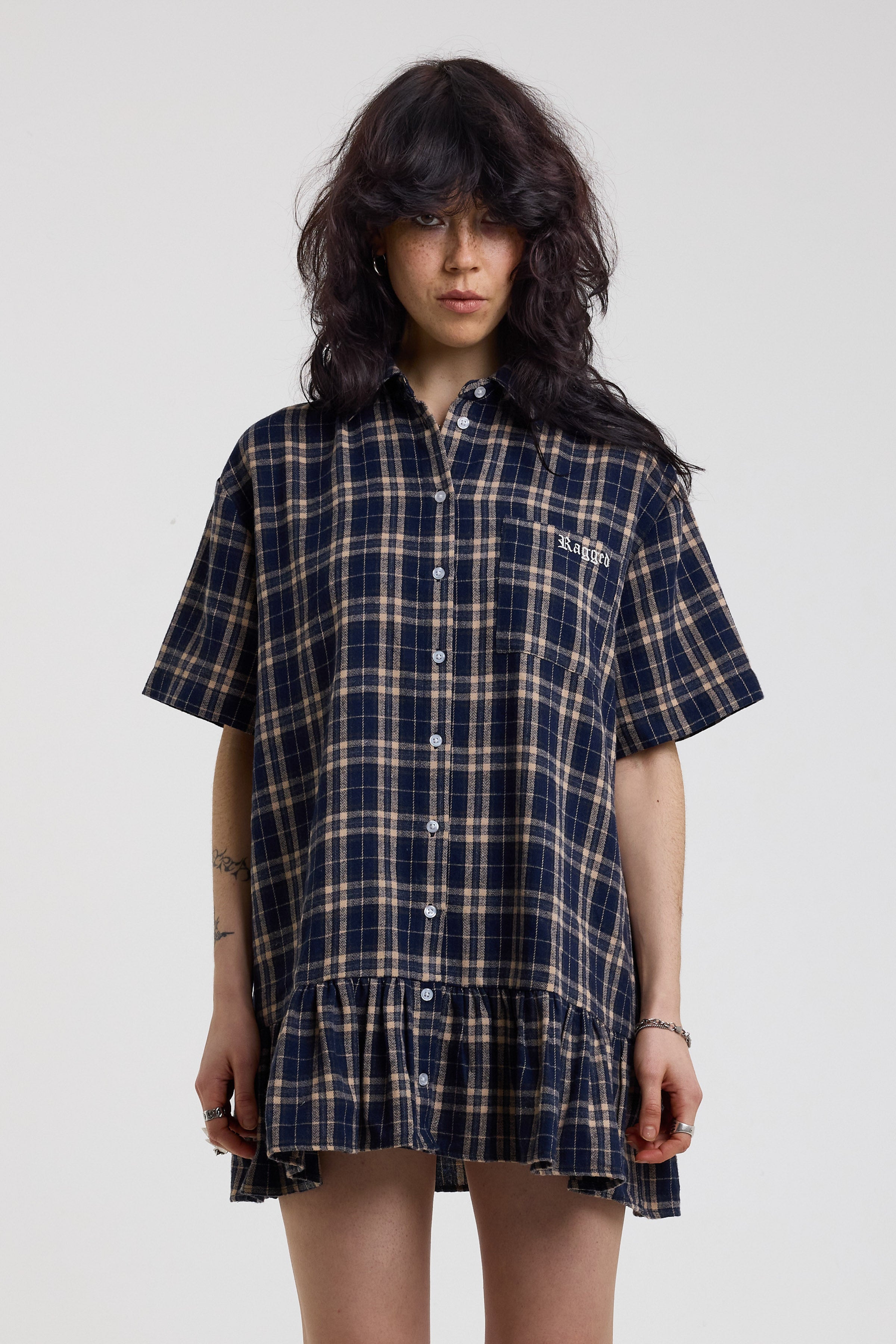 Navy and yellow check mini dress with button fastening, collar and peplum hem, worn by model