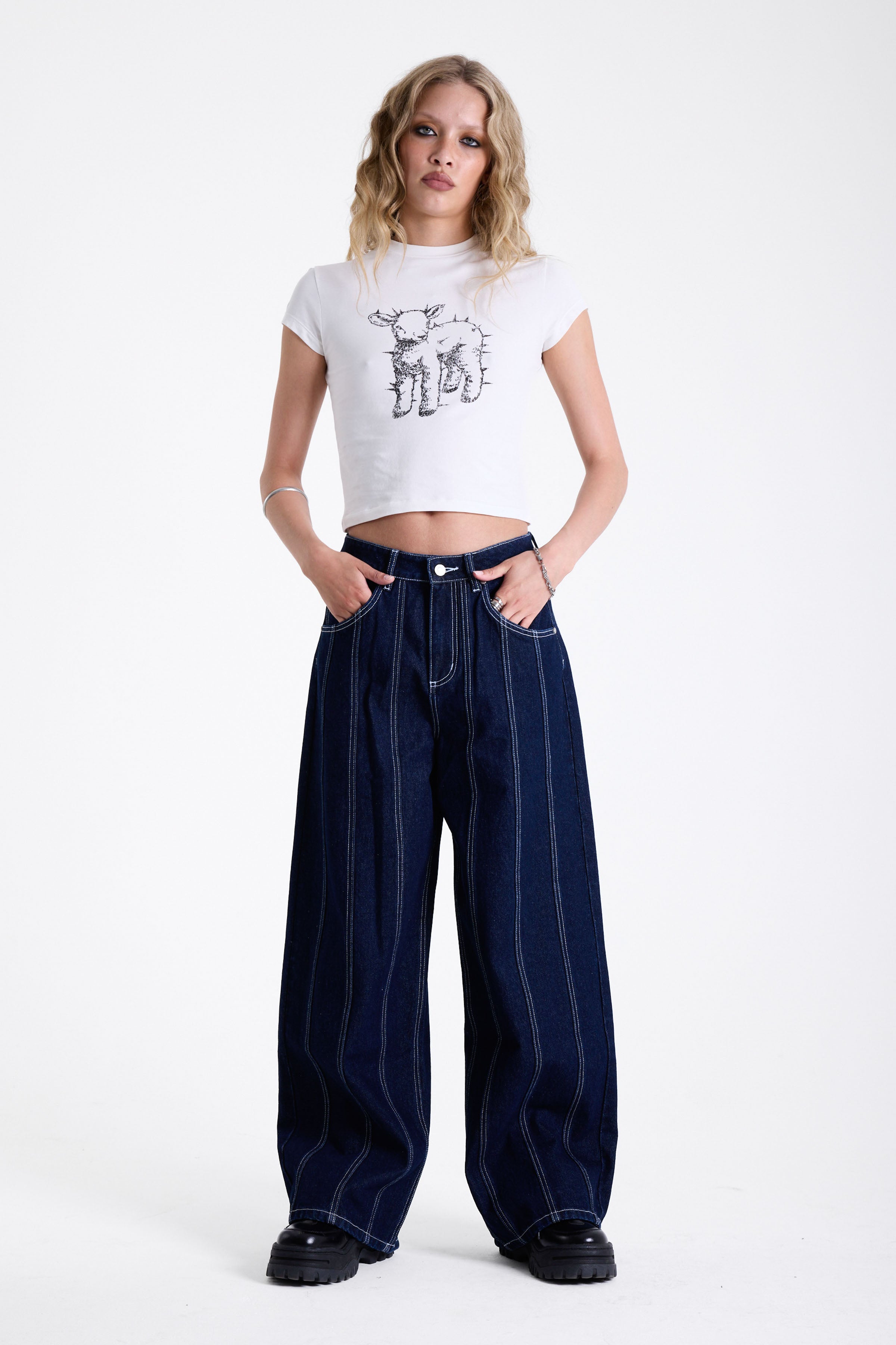 Dark rinse denim baggy wide leg jeans with contrast seam detail, worn by model.