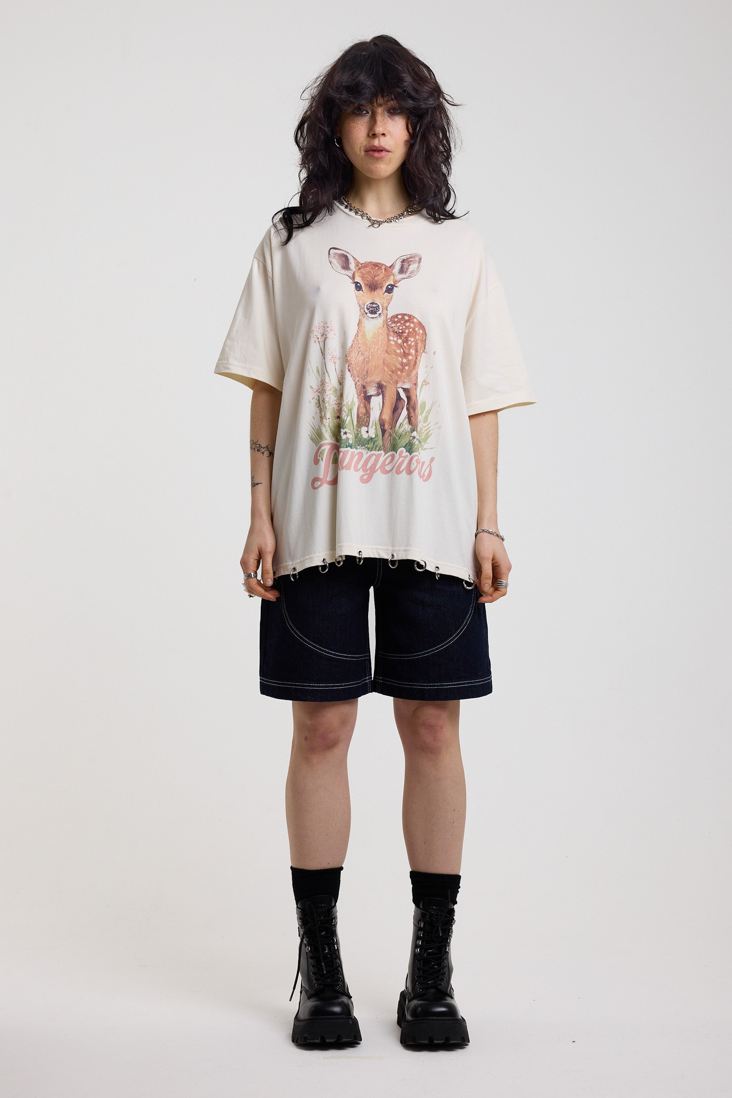 Off-white oversized t-shirt with graphic deer print and silver O-ring hardware detail, worn by model