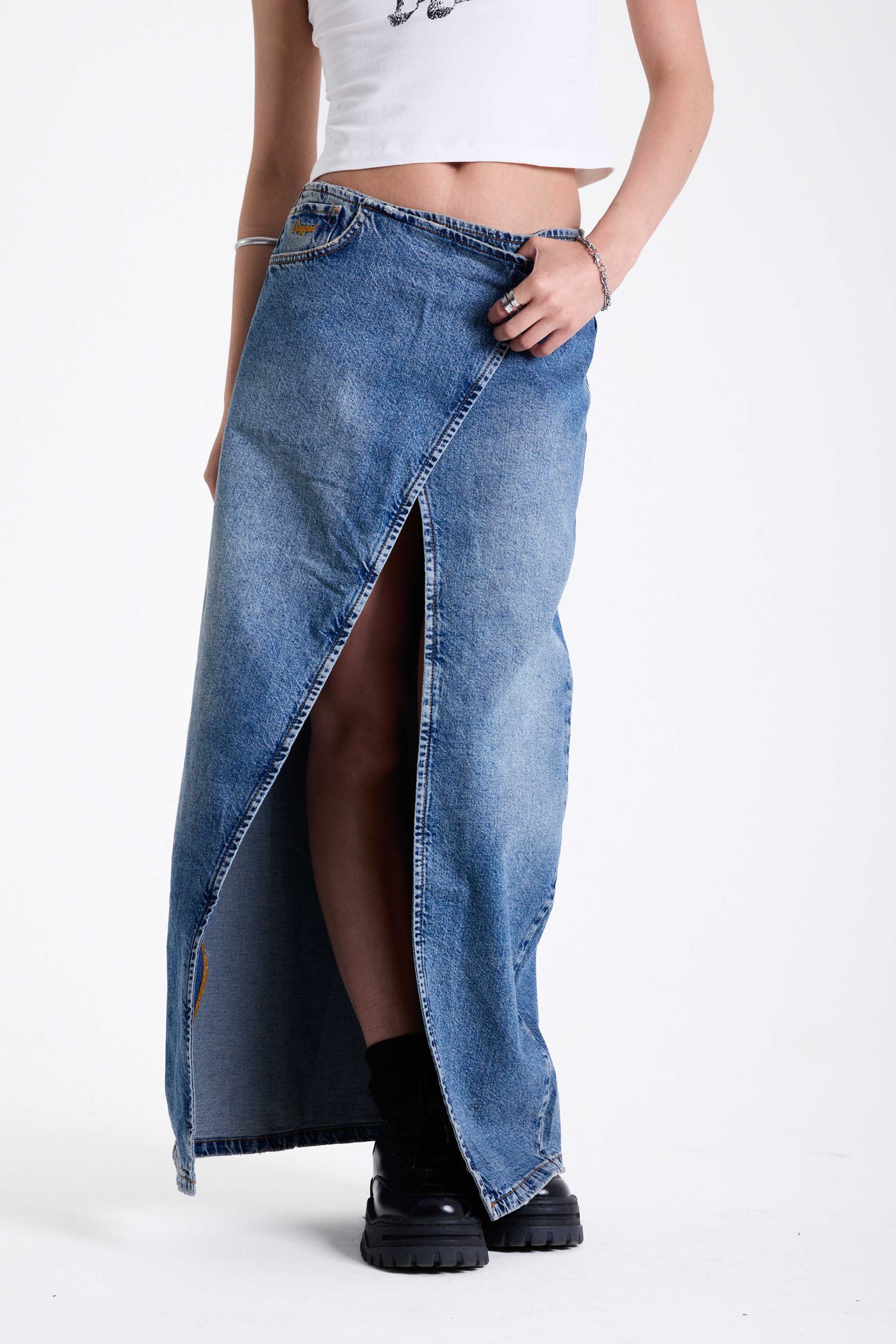 Vintage wash denim maxi skirt with thigh high split and buckle belt fastening, worn by model.