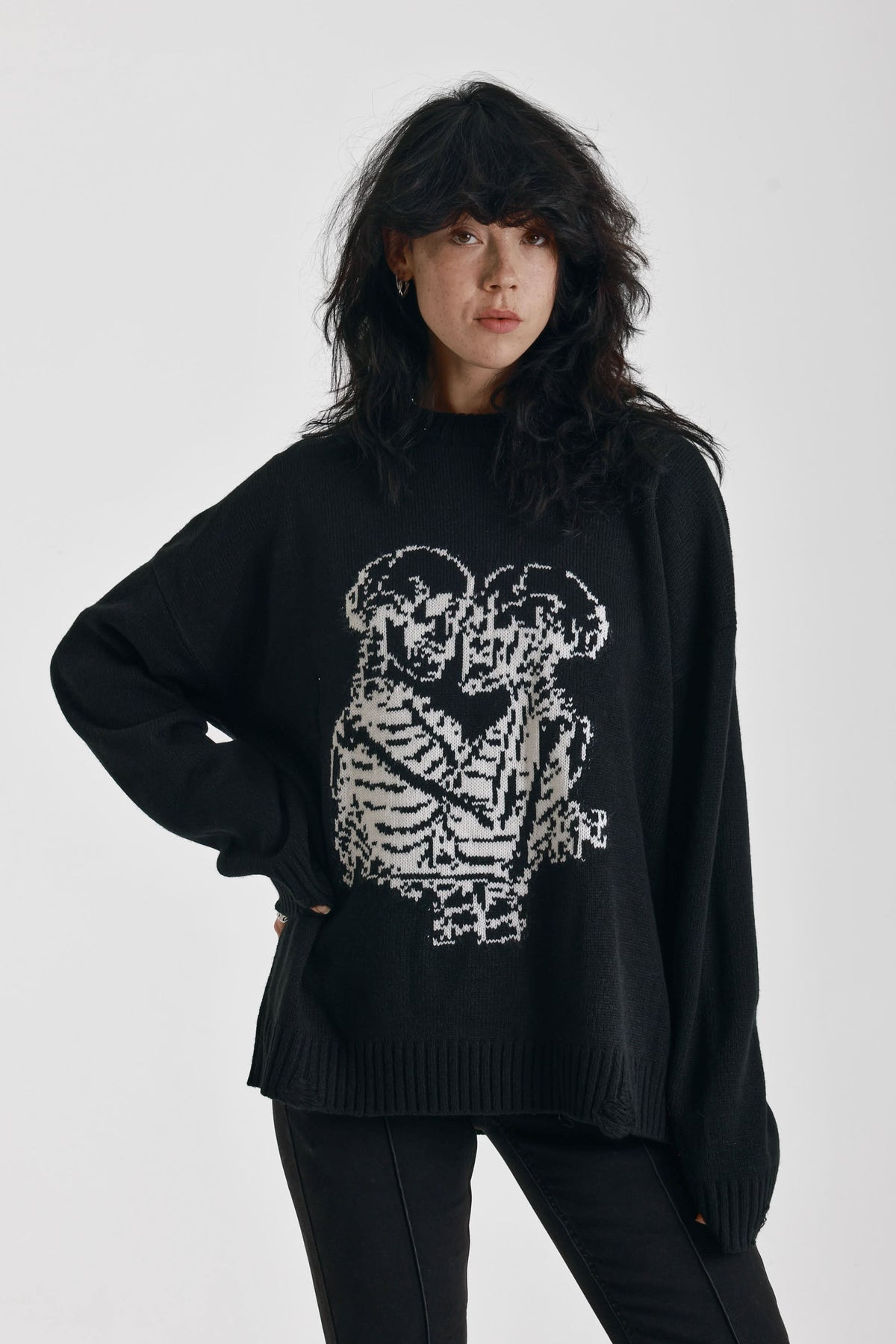 Black oversized knit jumper with skeleton graphic print, worn by model