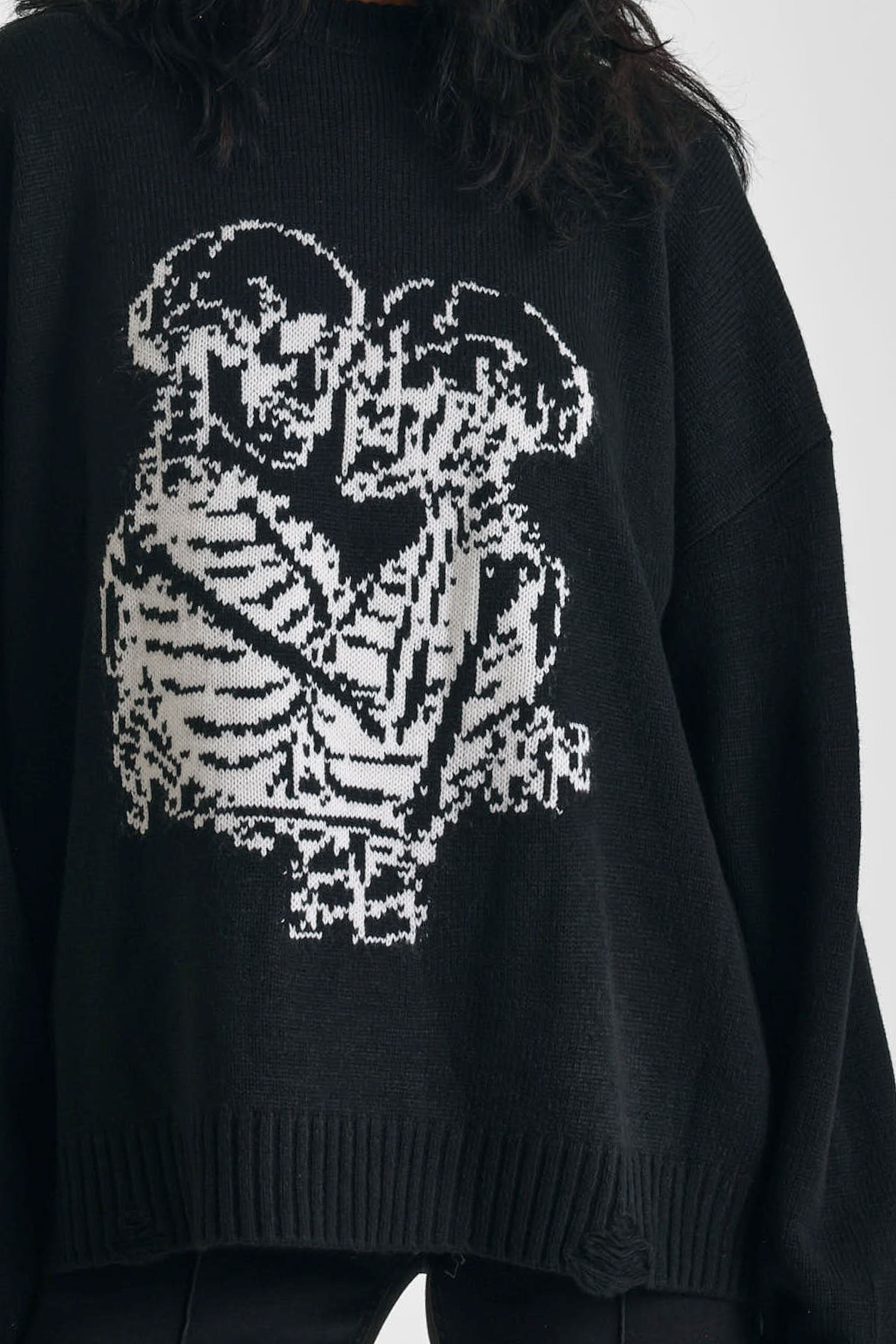 Black oversized knit jumper with skeleton graphic print, worn by model
