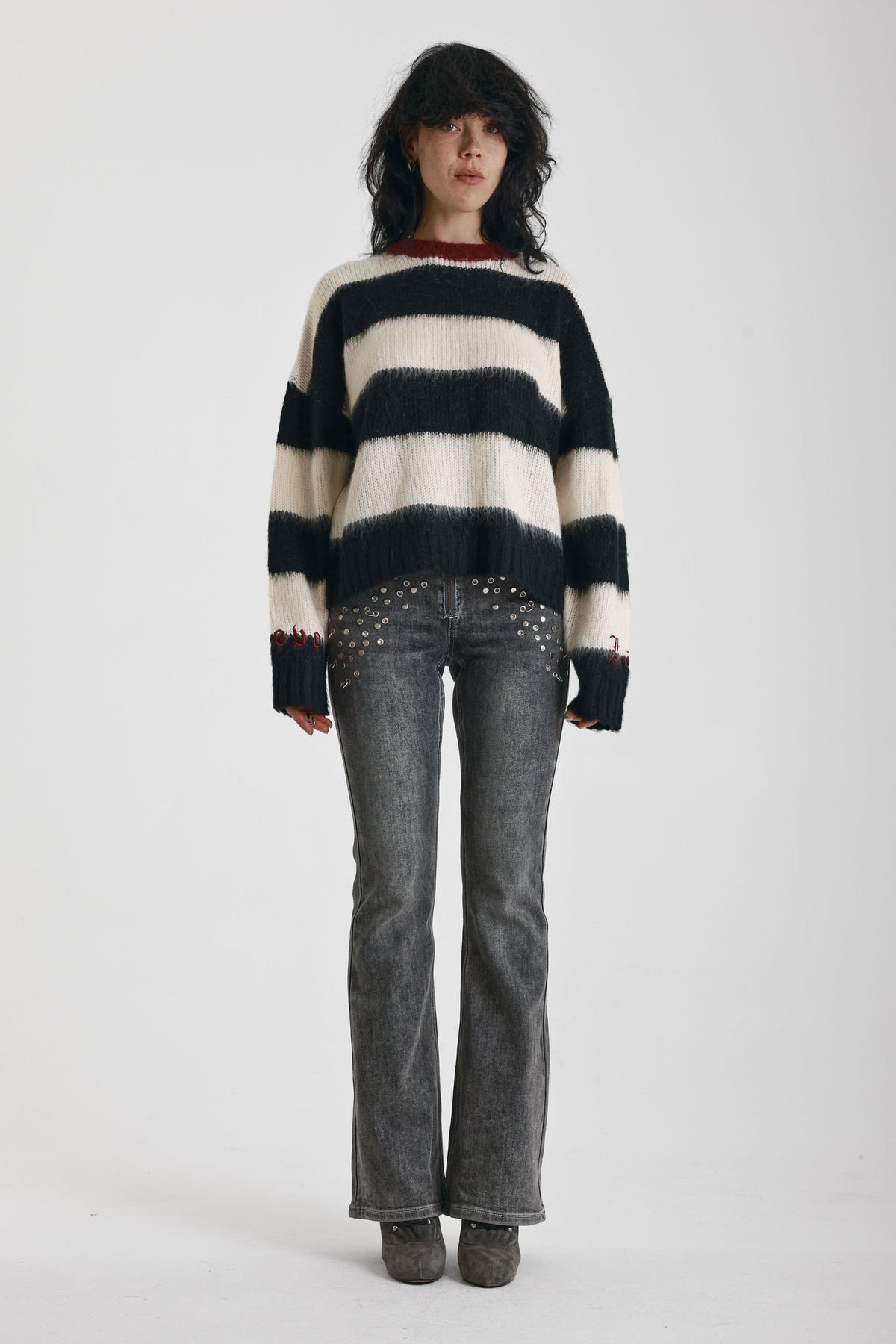 Black and white stripe fluffy knit jumper with burgundy crew neck, worn by model