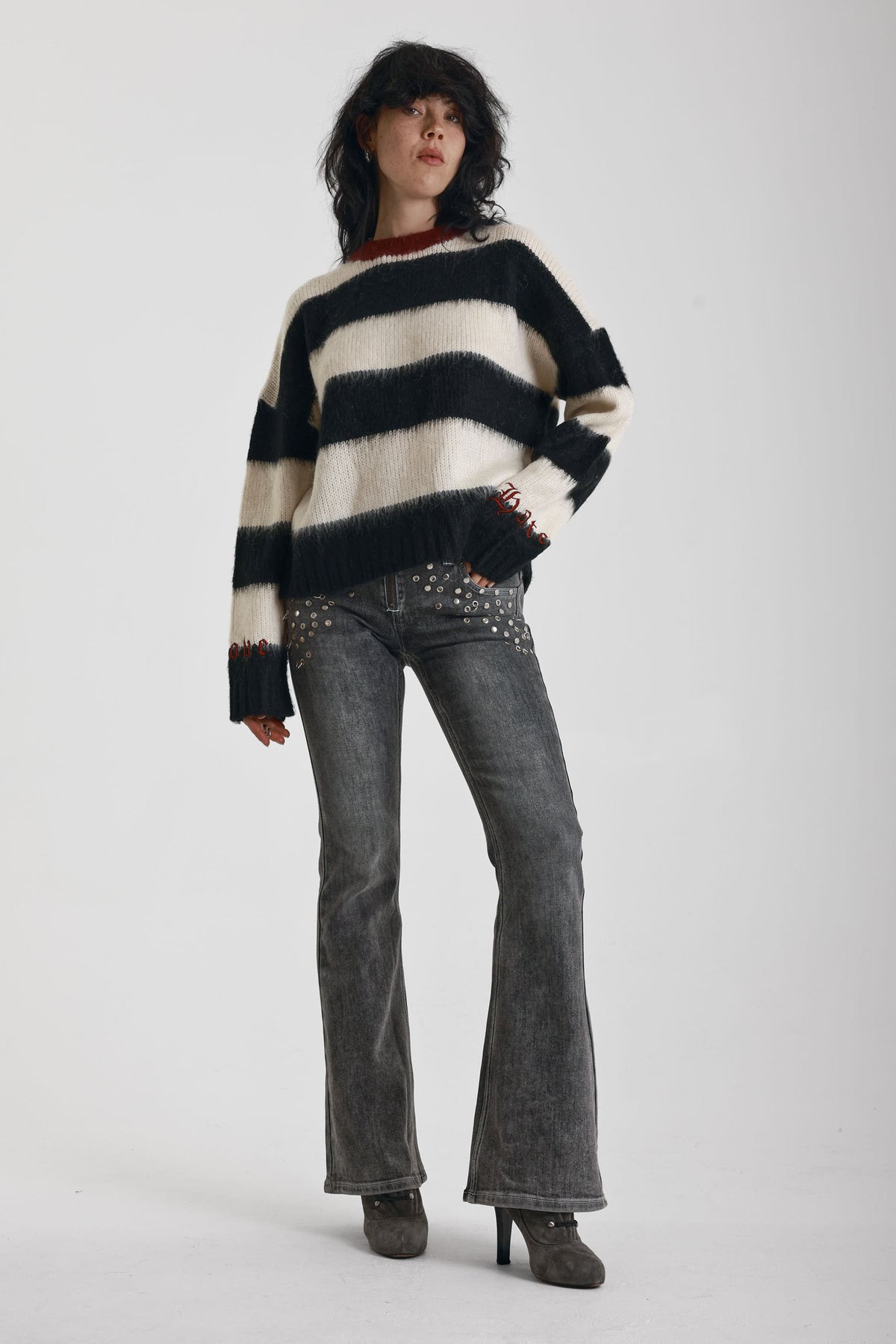 Black and white stripe fluffy knit jumper with burgundy crew neck, worn by model