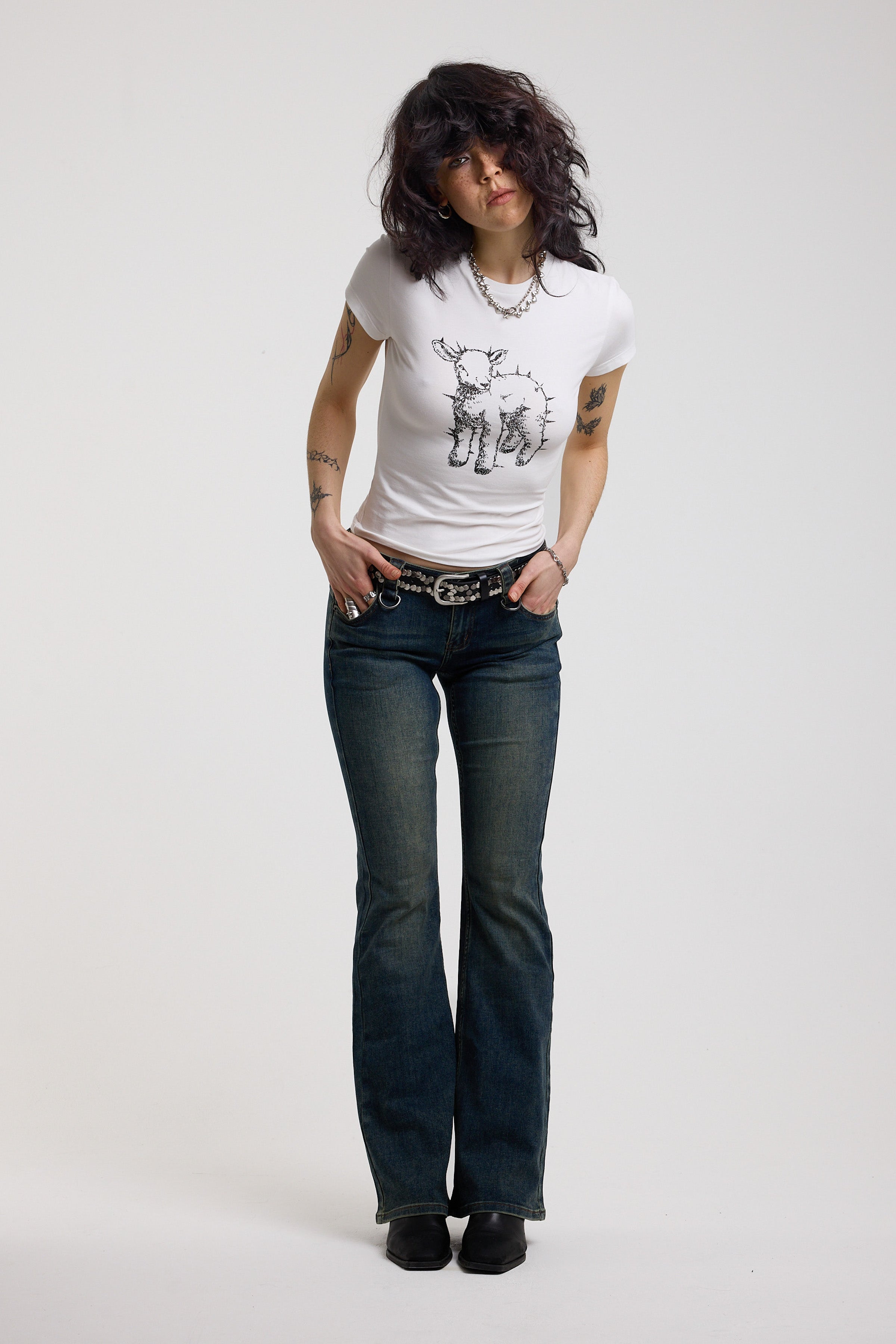 White shrunken baby t-shirt with spiked lamb graphic print, worn by a model
