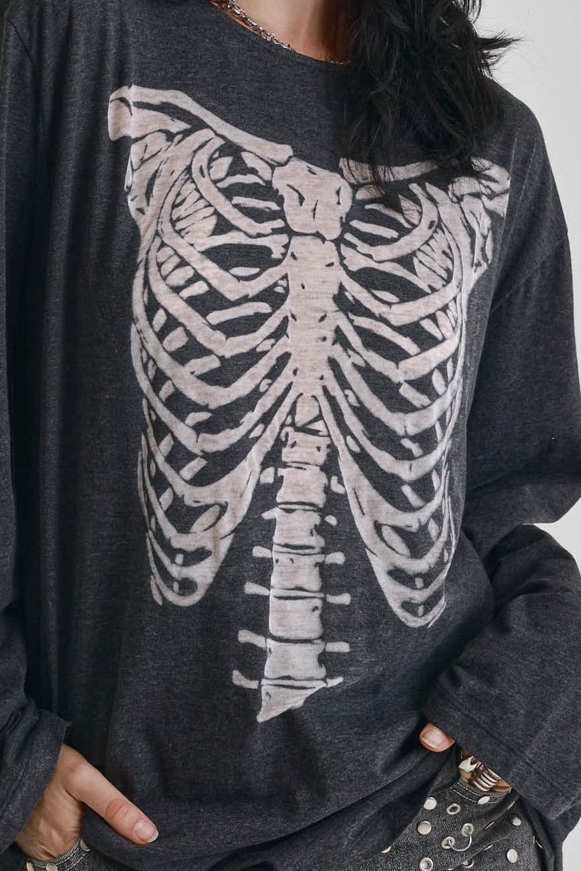 Washed black slouchy fit long sleeve t-shirt with skeleton ribcage burnout graphic, worn by model