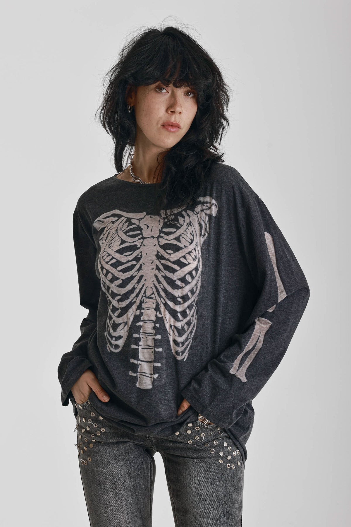 Washed black slouchy fit long sleeve t-shirt with skeleton ribcage burnout graphic, worn by model