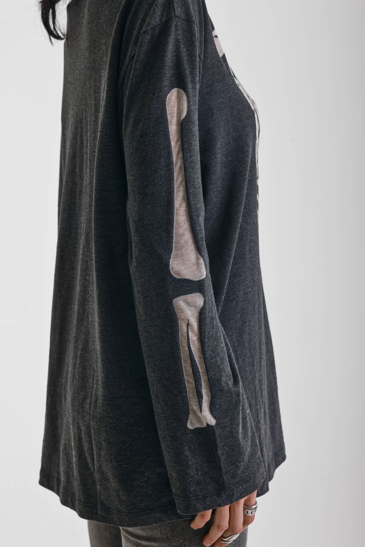 Washed black slouchy fit long sleeve t-shirt with skeleton ribcage burnout graphic, worn by model
