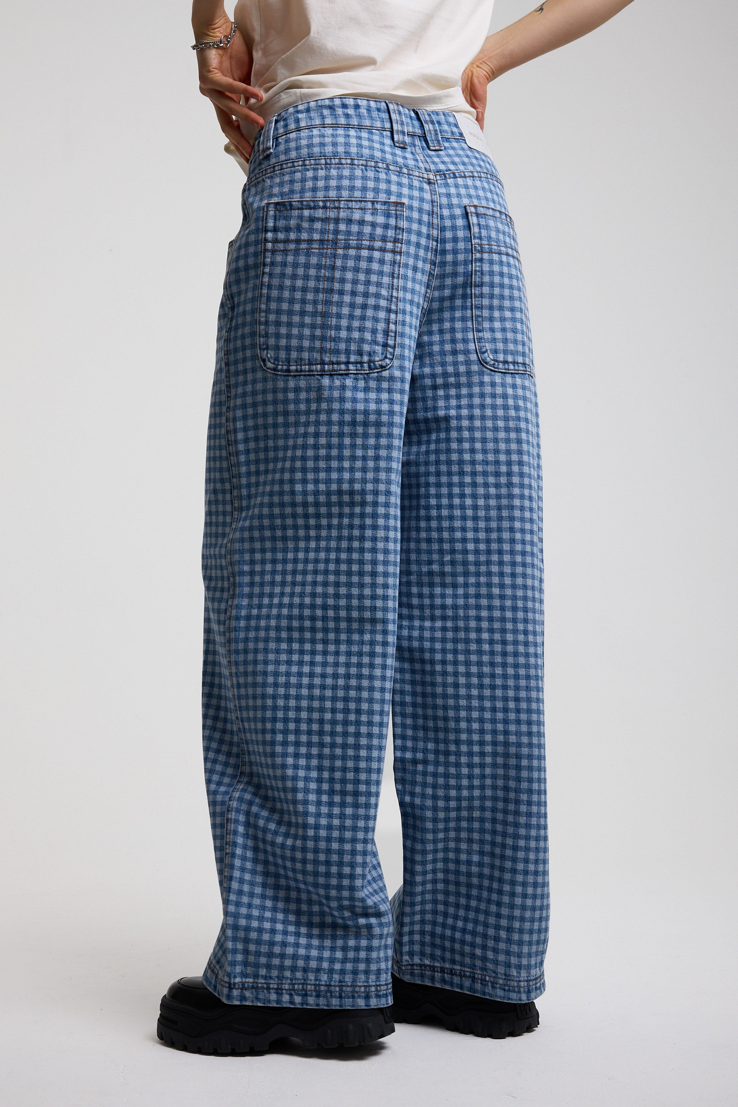 Back view of blue gingham checked baggy wide leg release jeans, worn by model