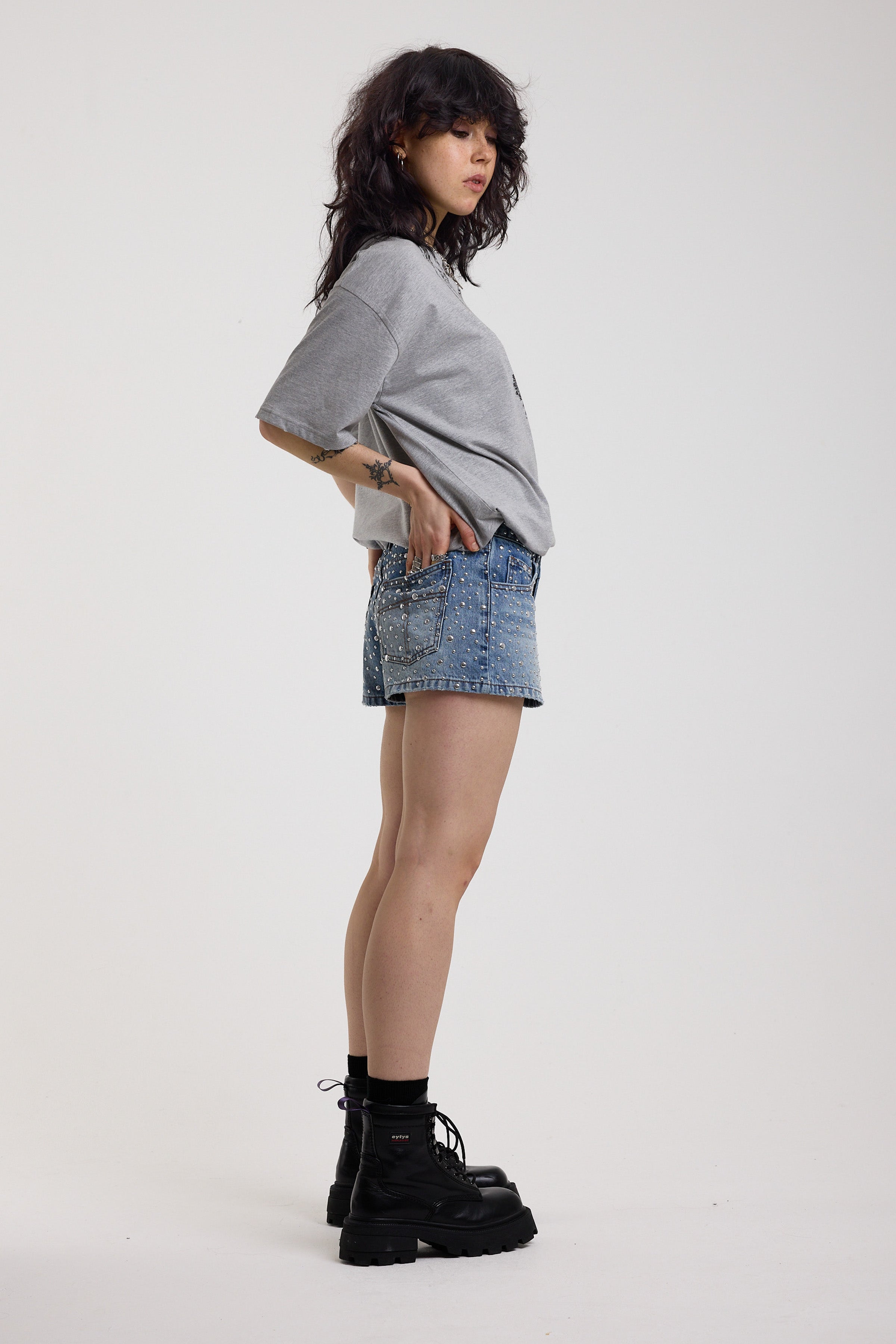 Light wash denim hotpants with all over hot fix silver studs, worn by model