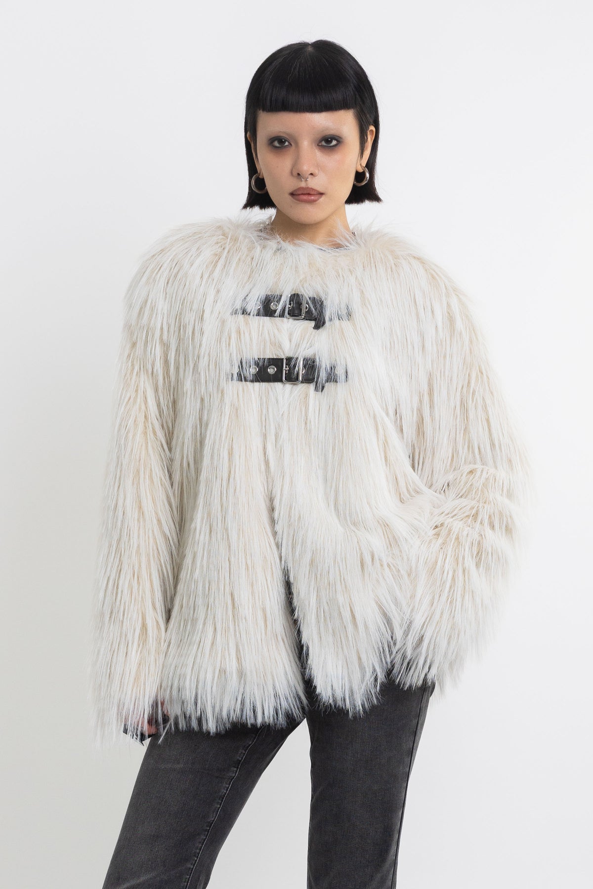 Ecru shaggy faux fur jacket with faux leather eyelet detail straps, worn by model