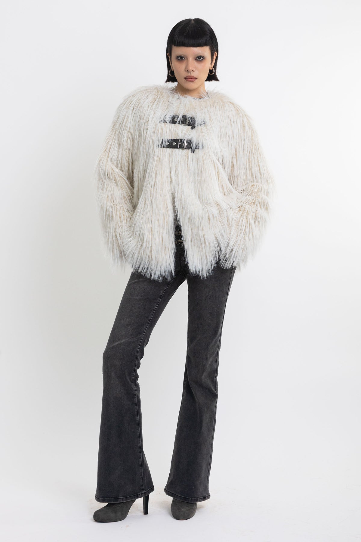 Ecru shaggy faux fur jacket with faux leather eyelet detail straps, worn by model