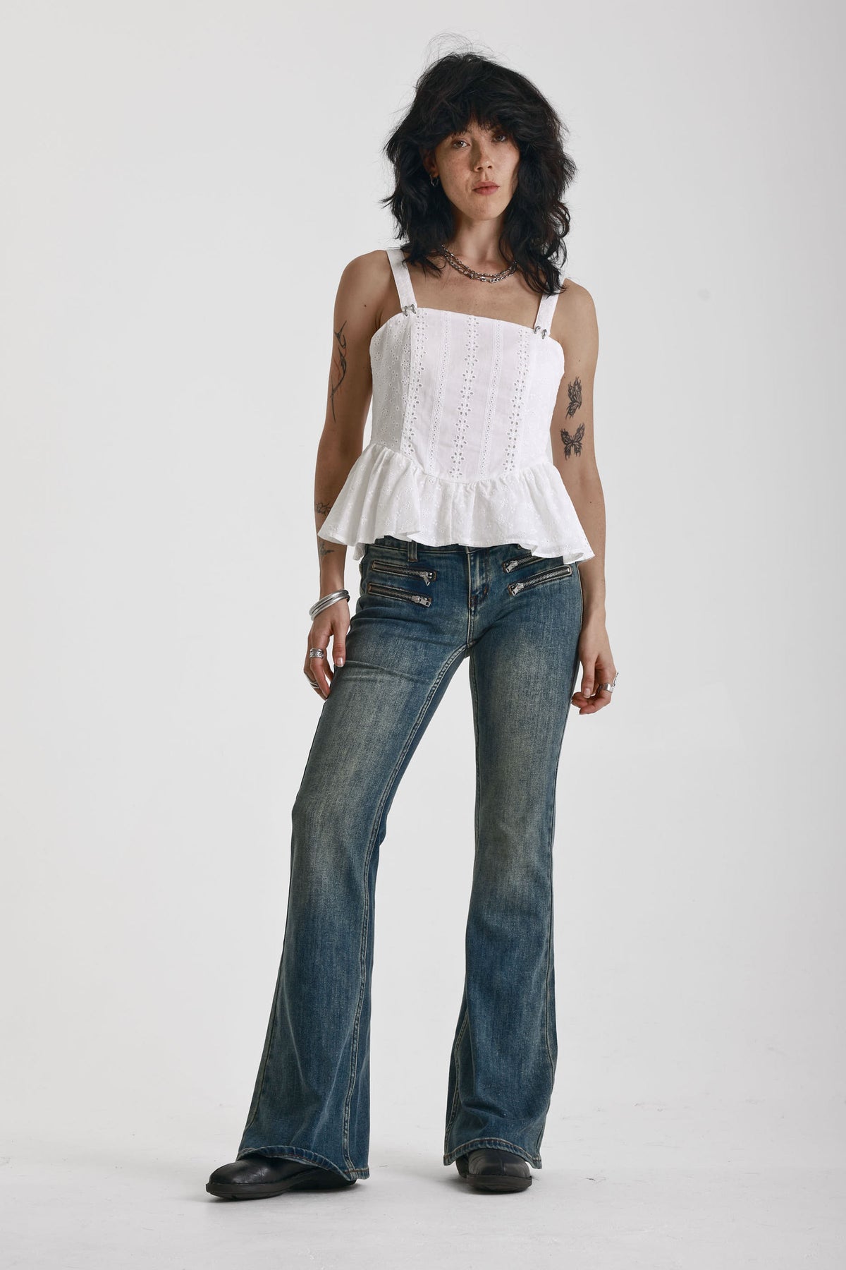 Dirty blue wash flare jeans with zip detail, worn by model