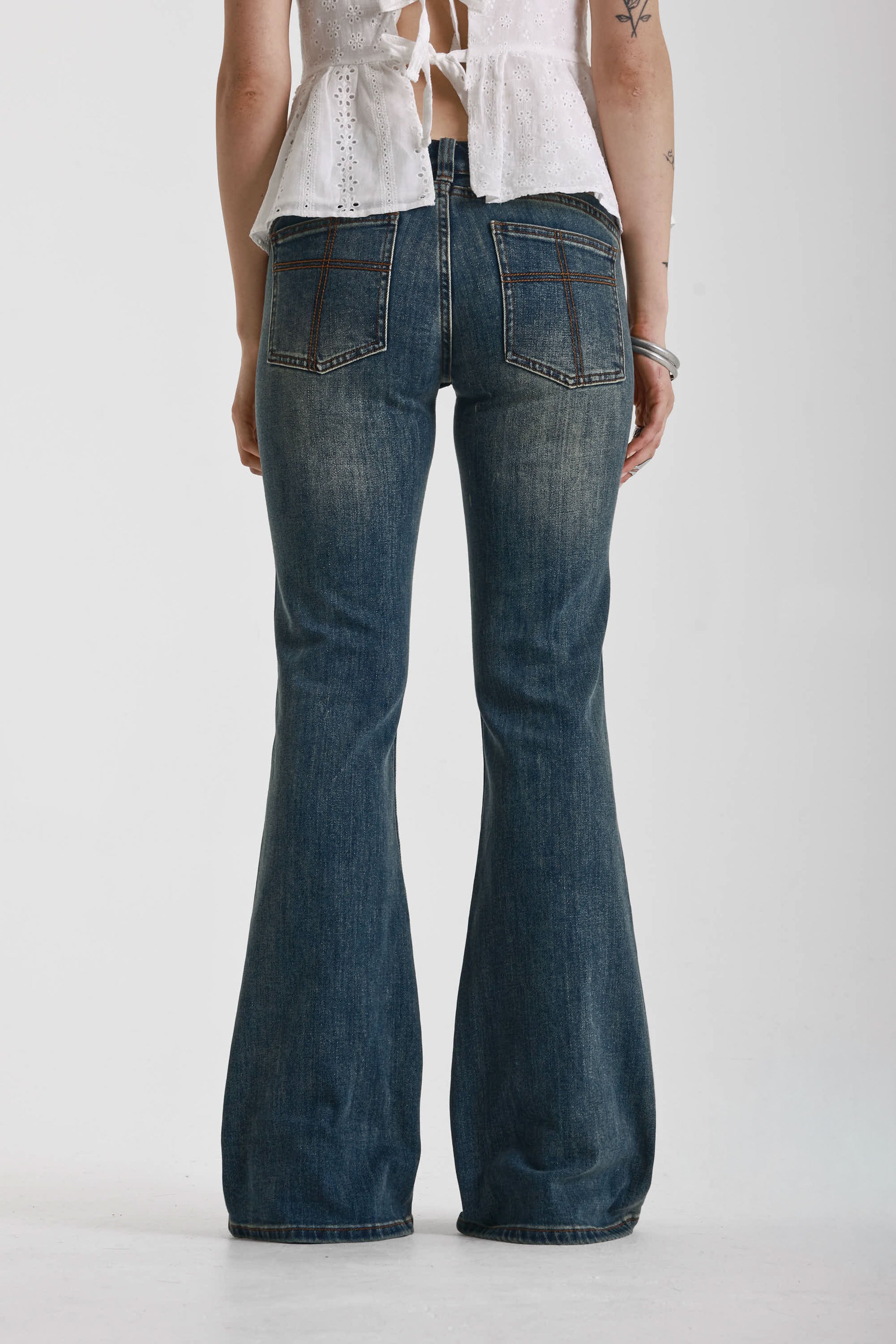 Dirty blue wash flare jeans with zip detail, worn by model