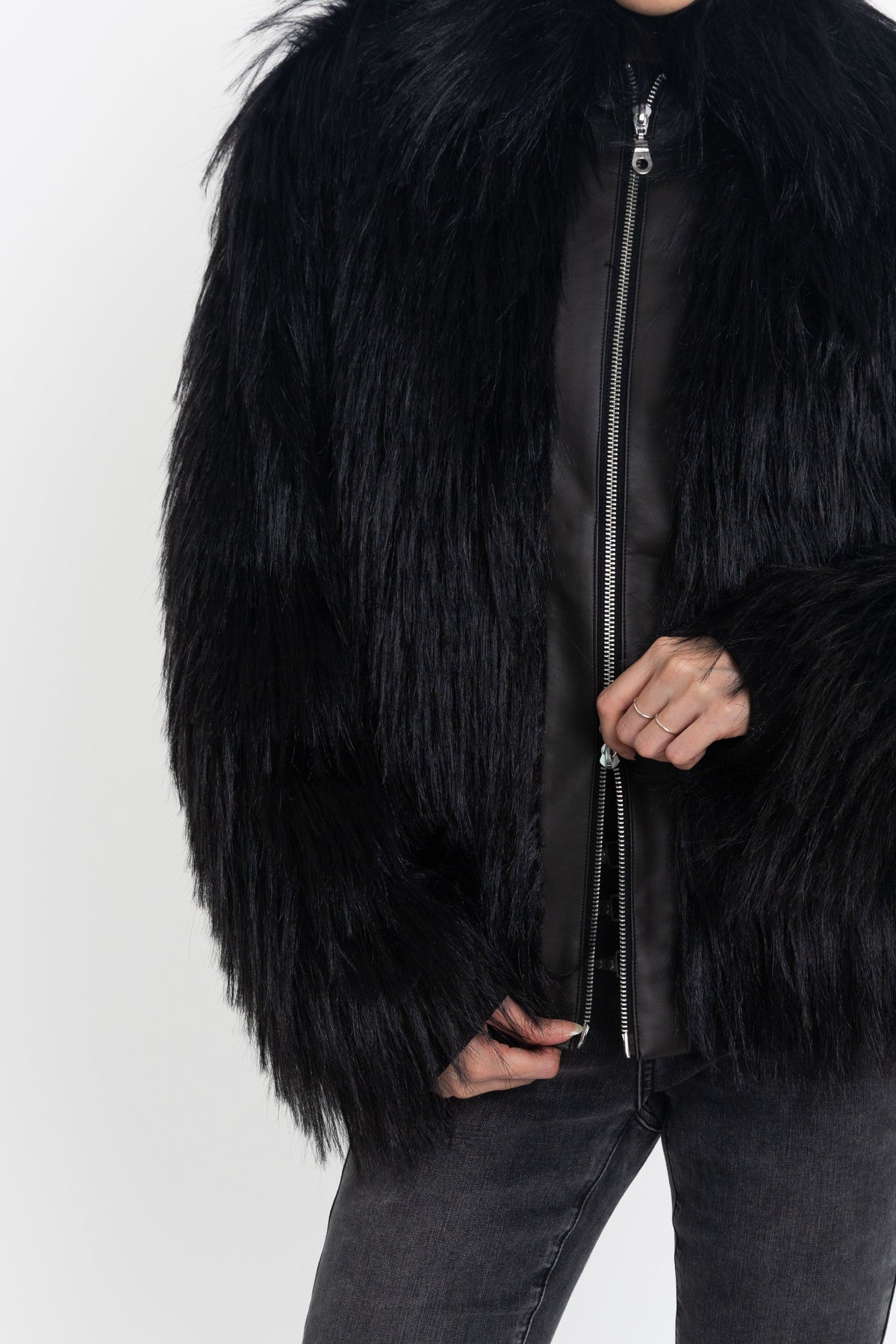 Black shaggy faux fur jacket with pu faux leather panel, worn by model