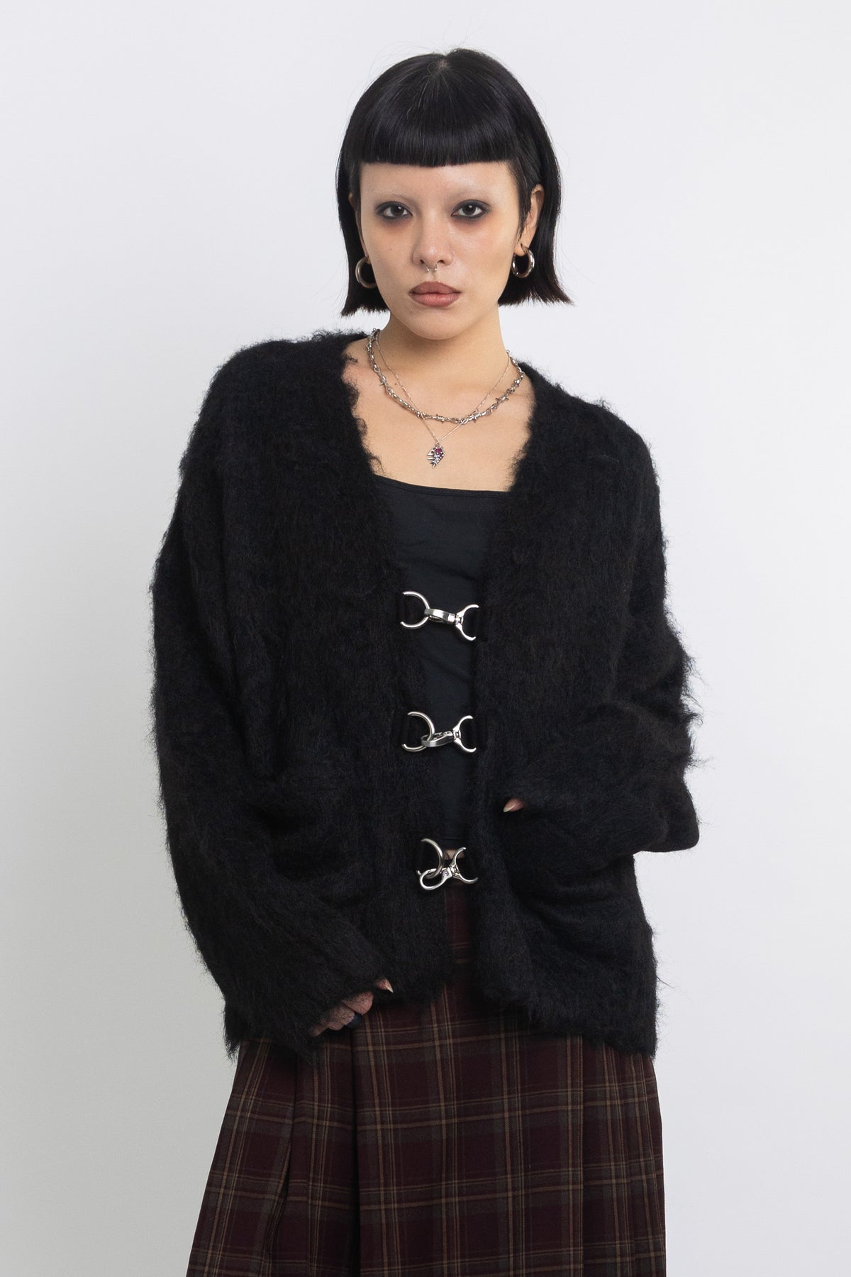 Black fluffy longline v-neck cardigan with oversized silver horsebit hardware clasps, worn by model