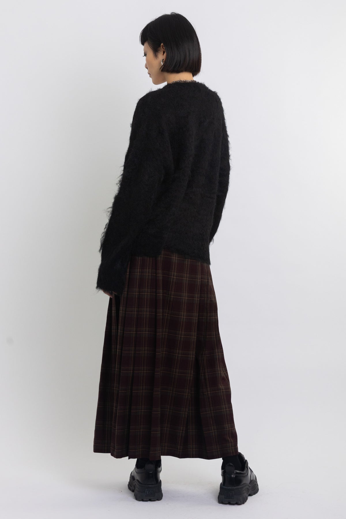 Black fluffy longline v-neck cardigan with oversized silver horsebit hardware clasps, worn by model
