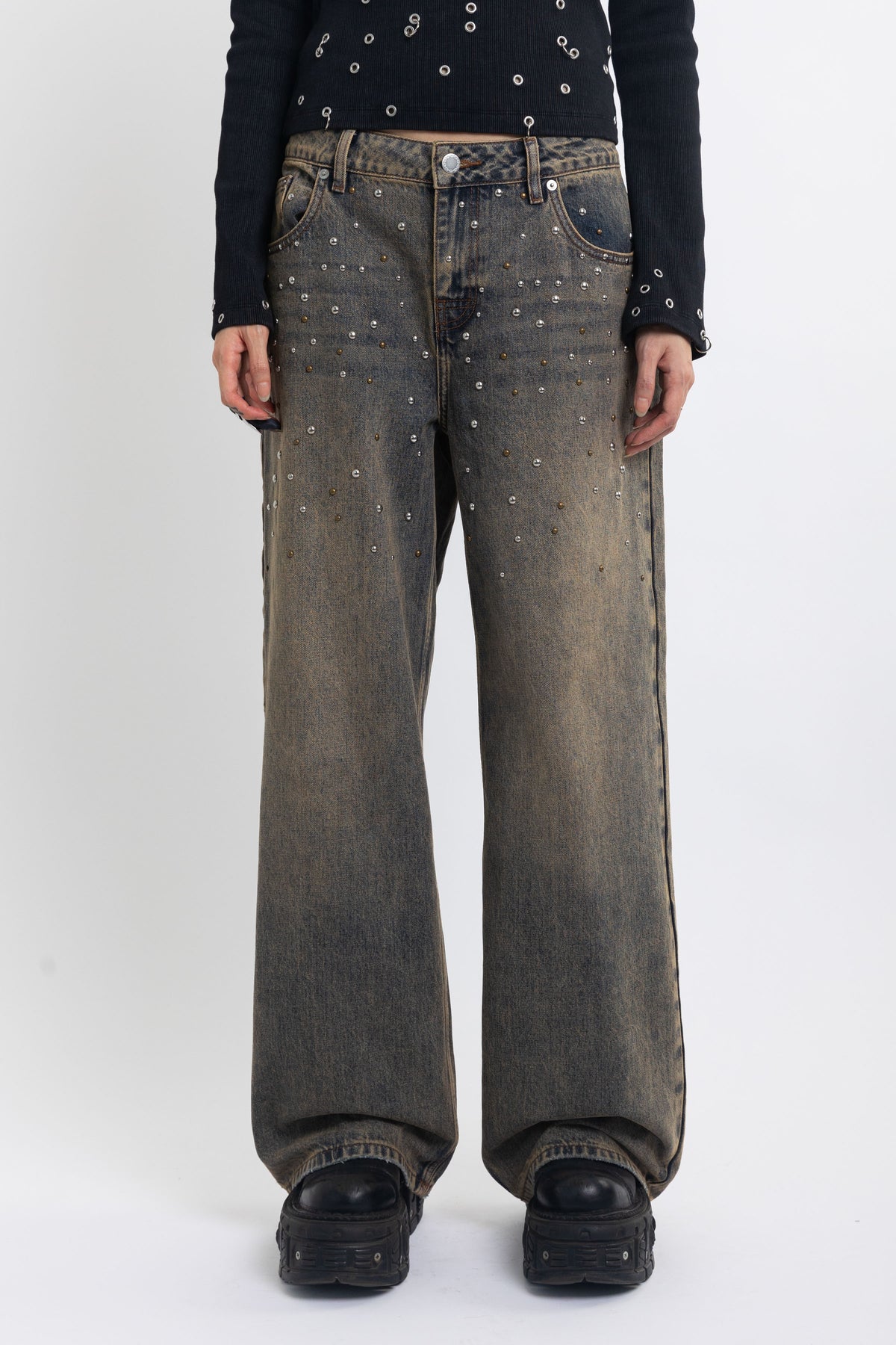 Dirty wash ultra baggy colossus jeans with scattered studs, worn by model