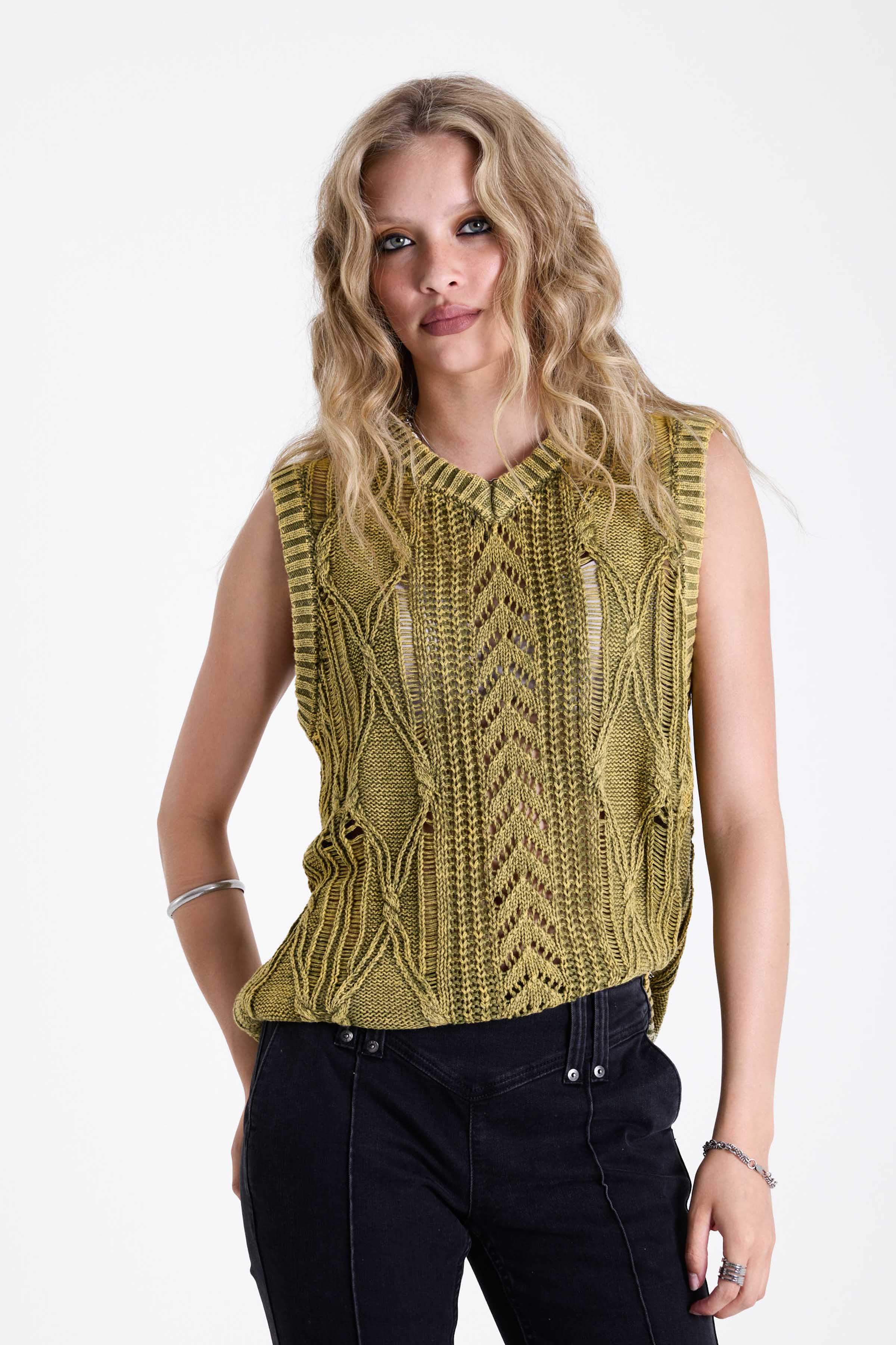 Acid wash green cable knit sweater vest, worn by model.