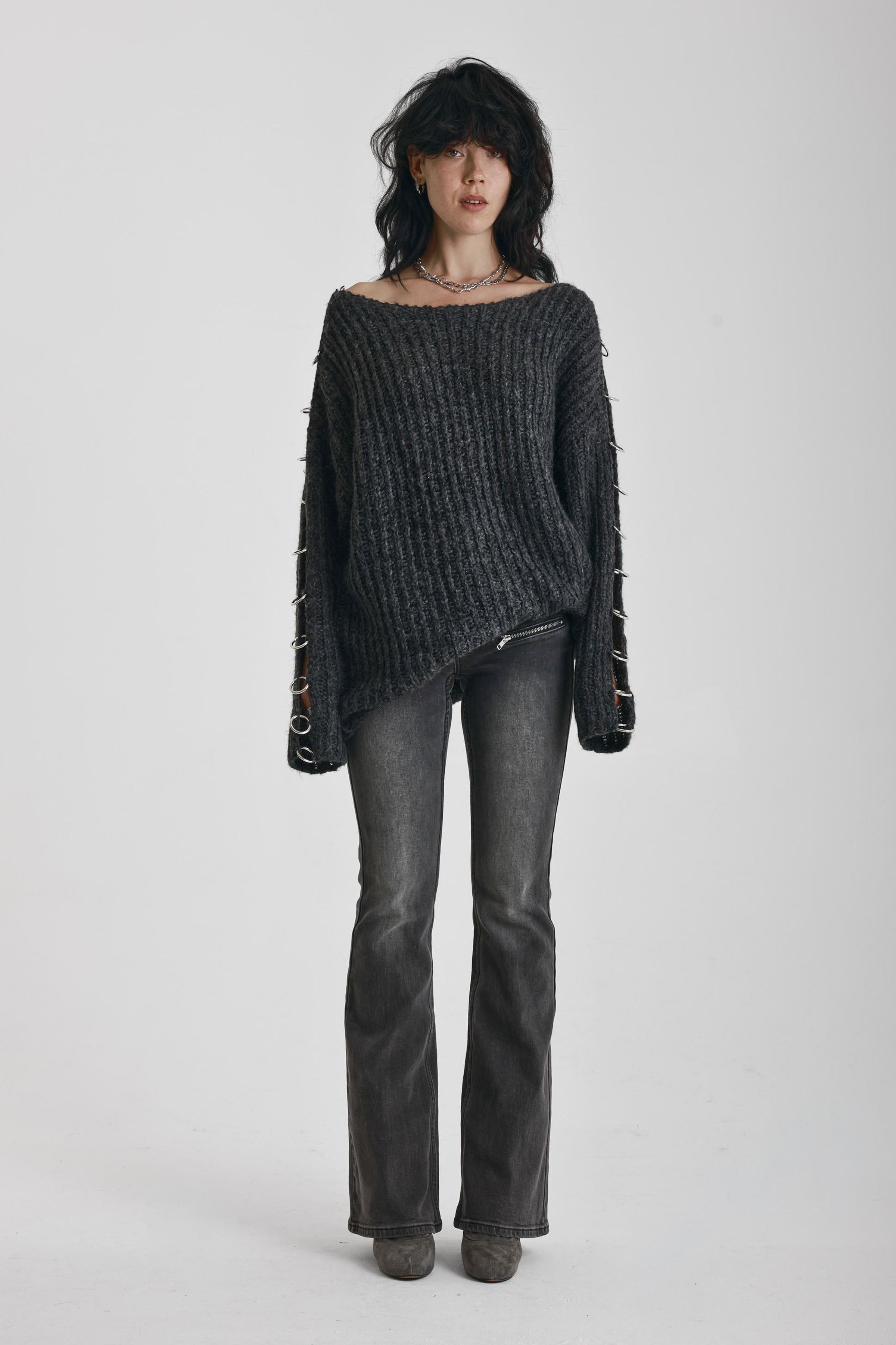 Chunky ribbed knit jumper with slash neck and O-ring cut outs, worn by model