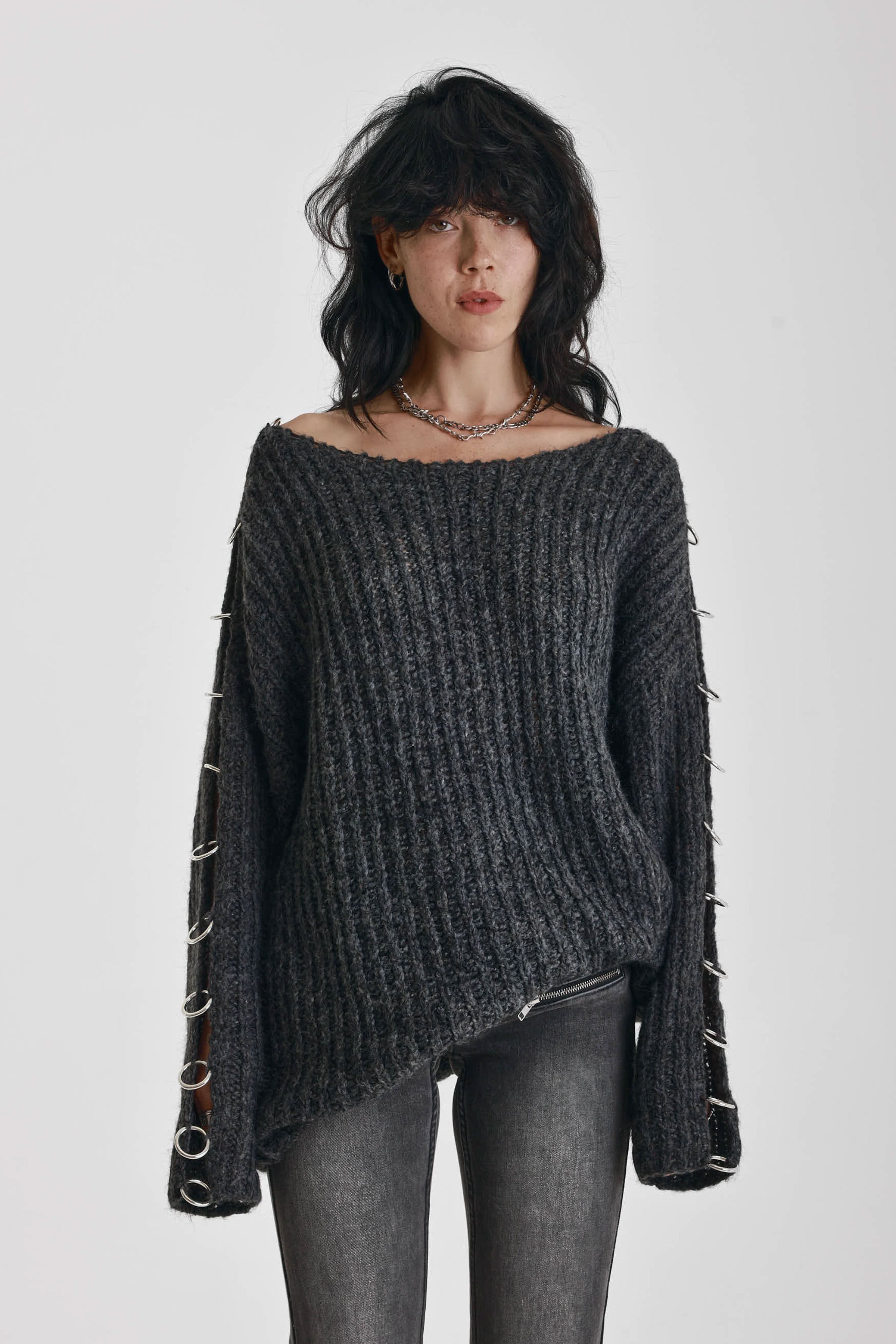Chunky ribbed knit jumper with slash neck and O-ring cut outs, worn by model