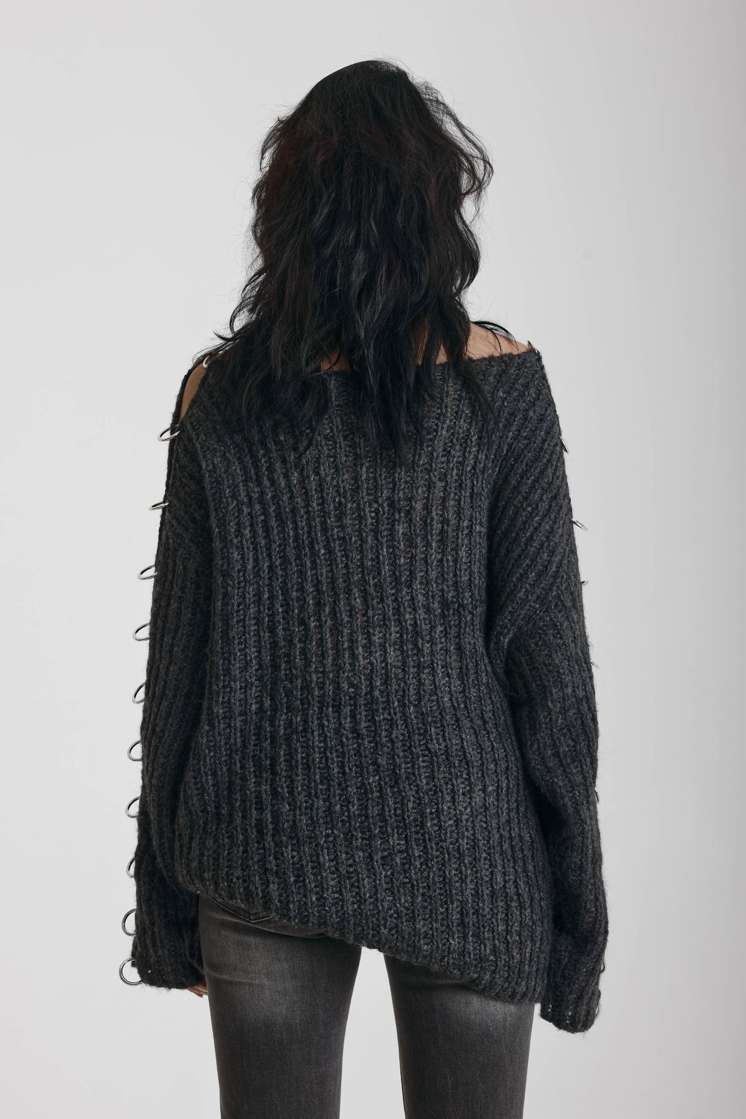 Chunky ribbed knit jumper with slash neck and O-ring cut outs, worn by model
