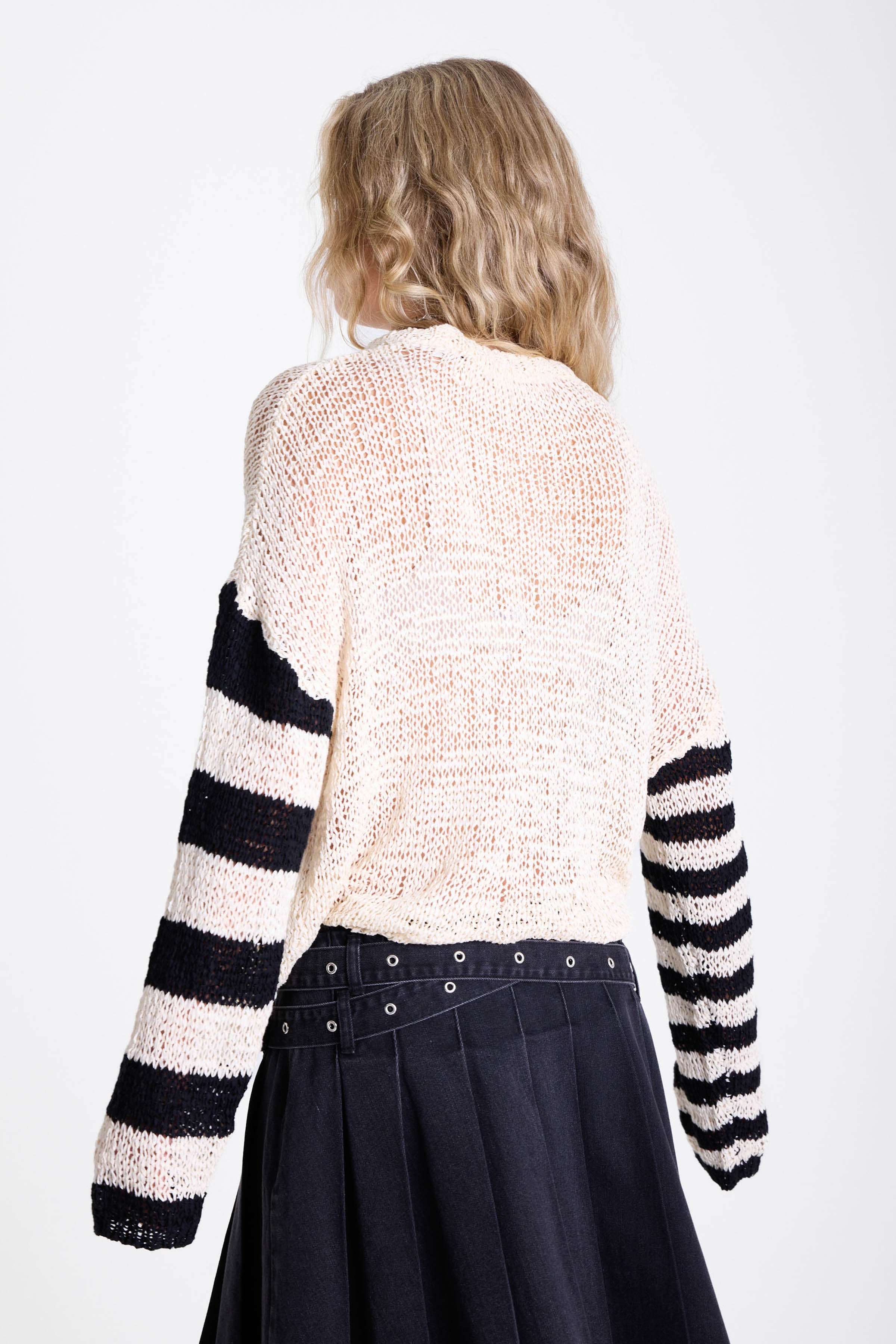 White relaxed open knit jumper with contrasting stripe sleeves, worn by model