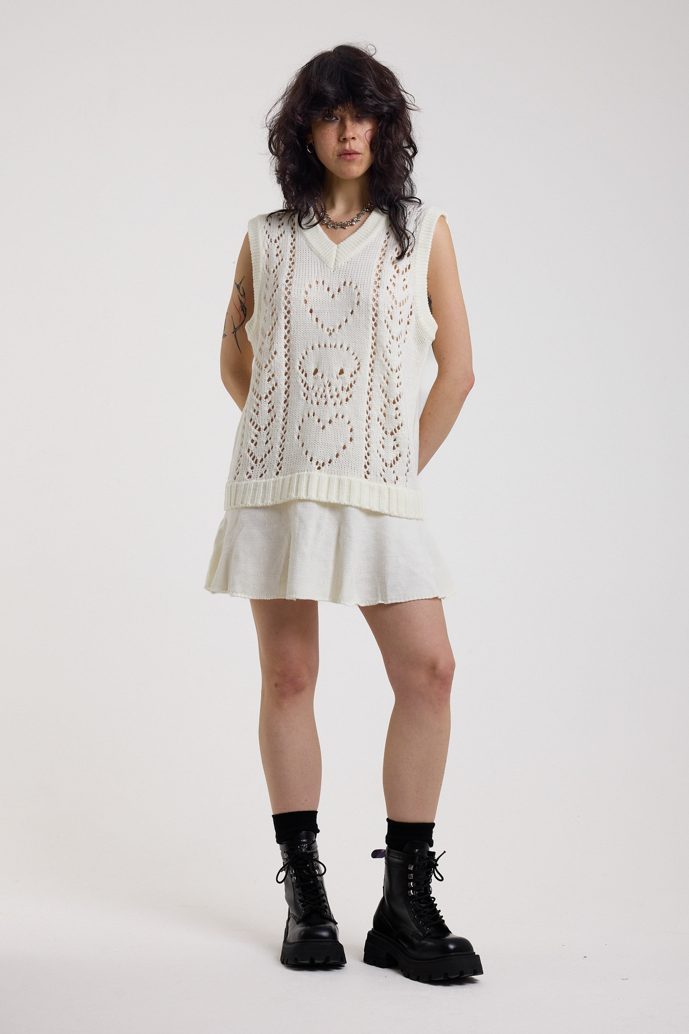 Off-white skull and heart pointelle knit mini dress with peplum hem, worn by model