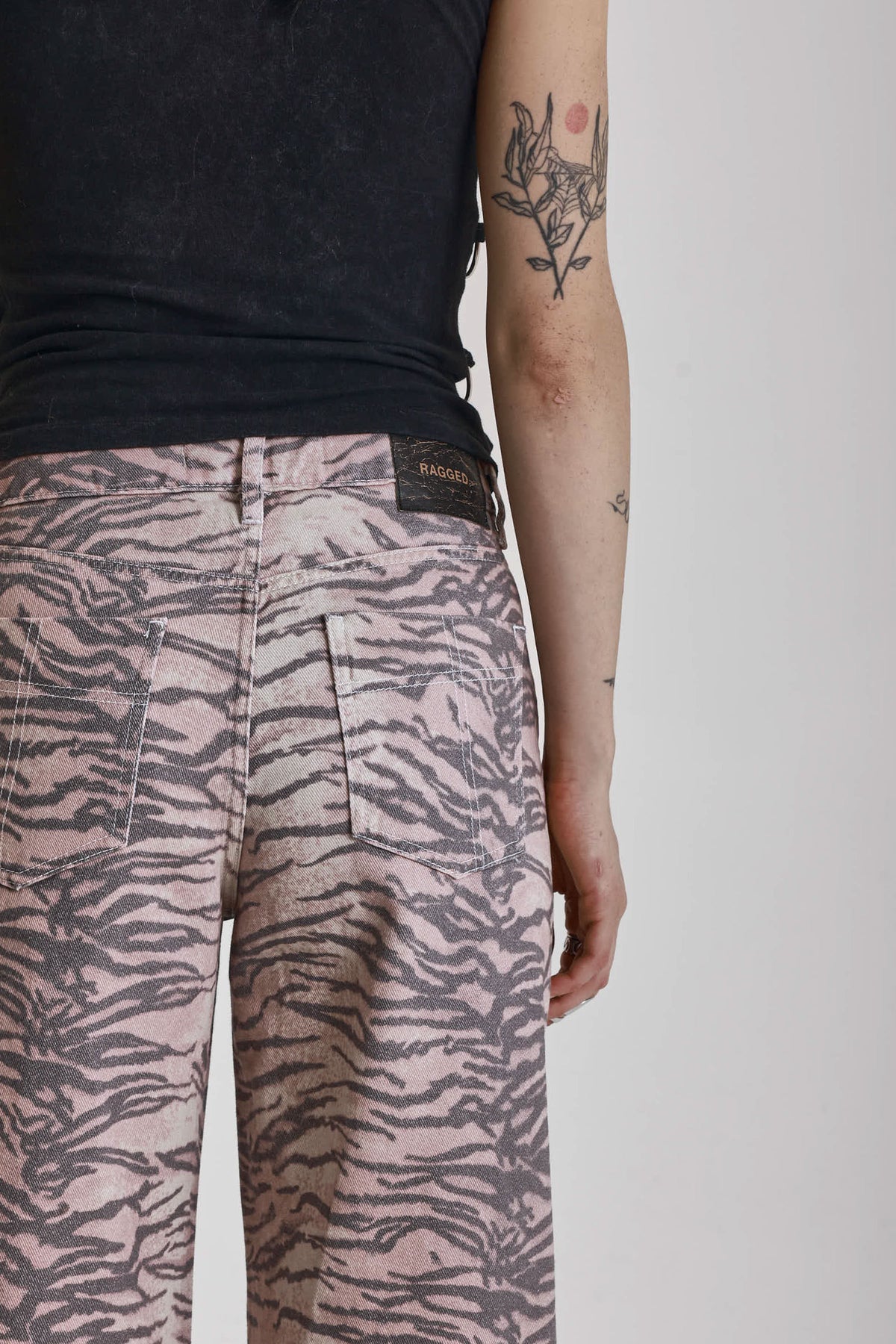 Brown tiger print relaxed straight leg jeans, worn by model