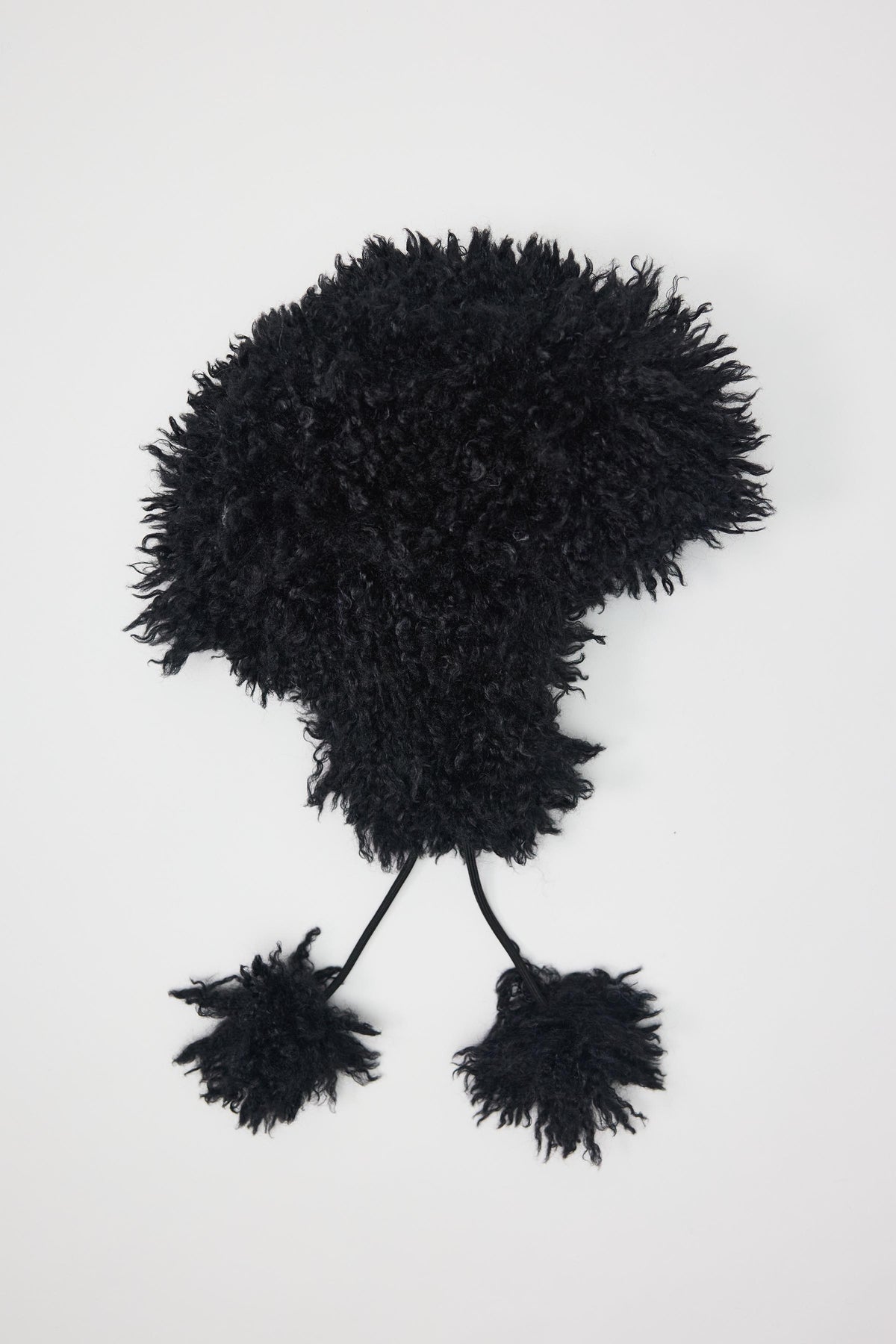 Black shaggy faux fur trapper hat with pom poms