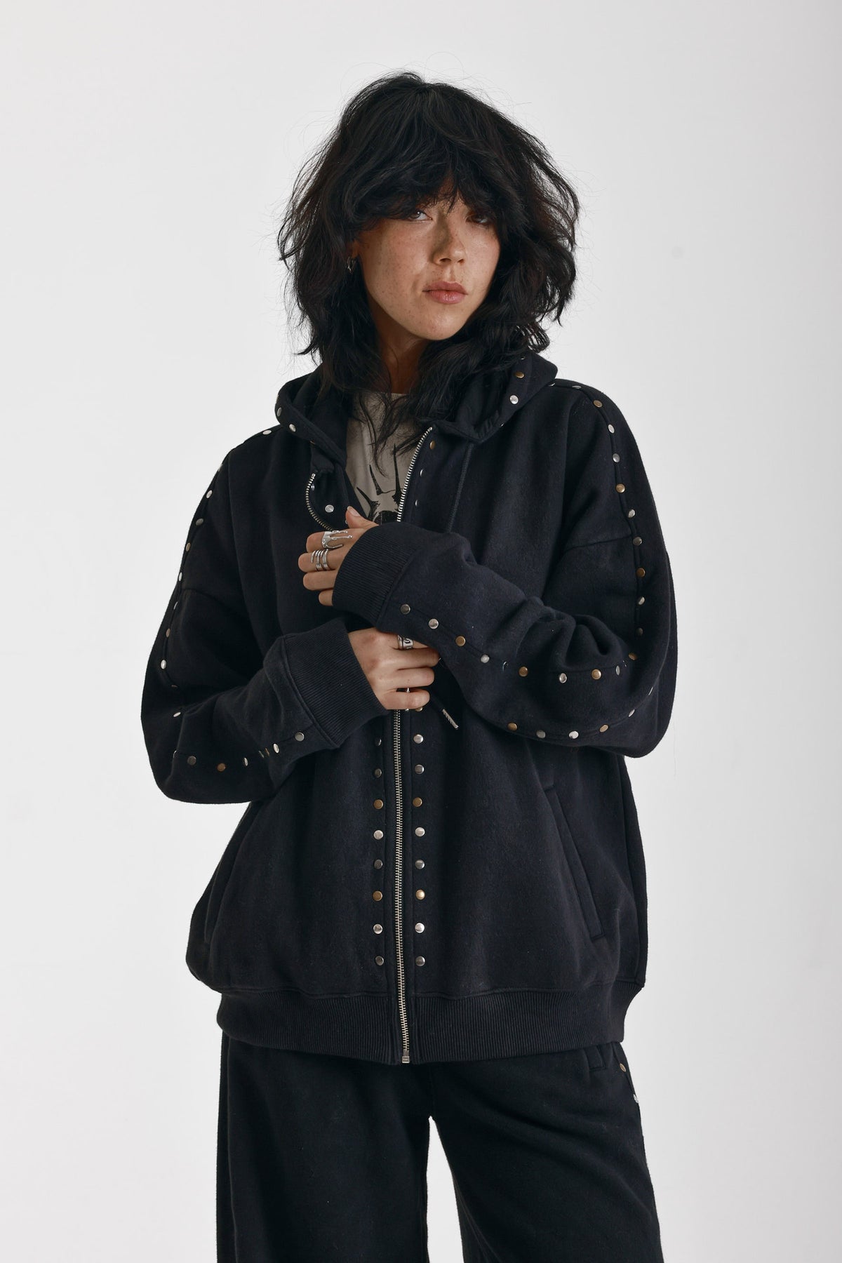 Washed black oversized zip up hoodie with mixed metal stud detail, worn by model