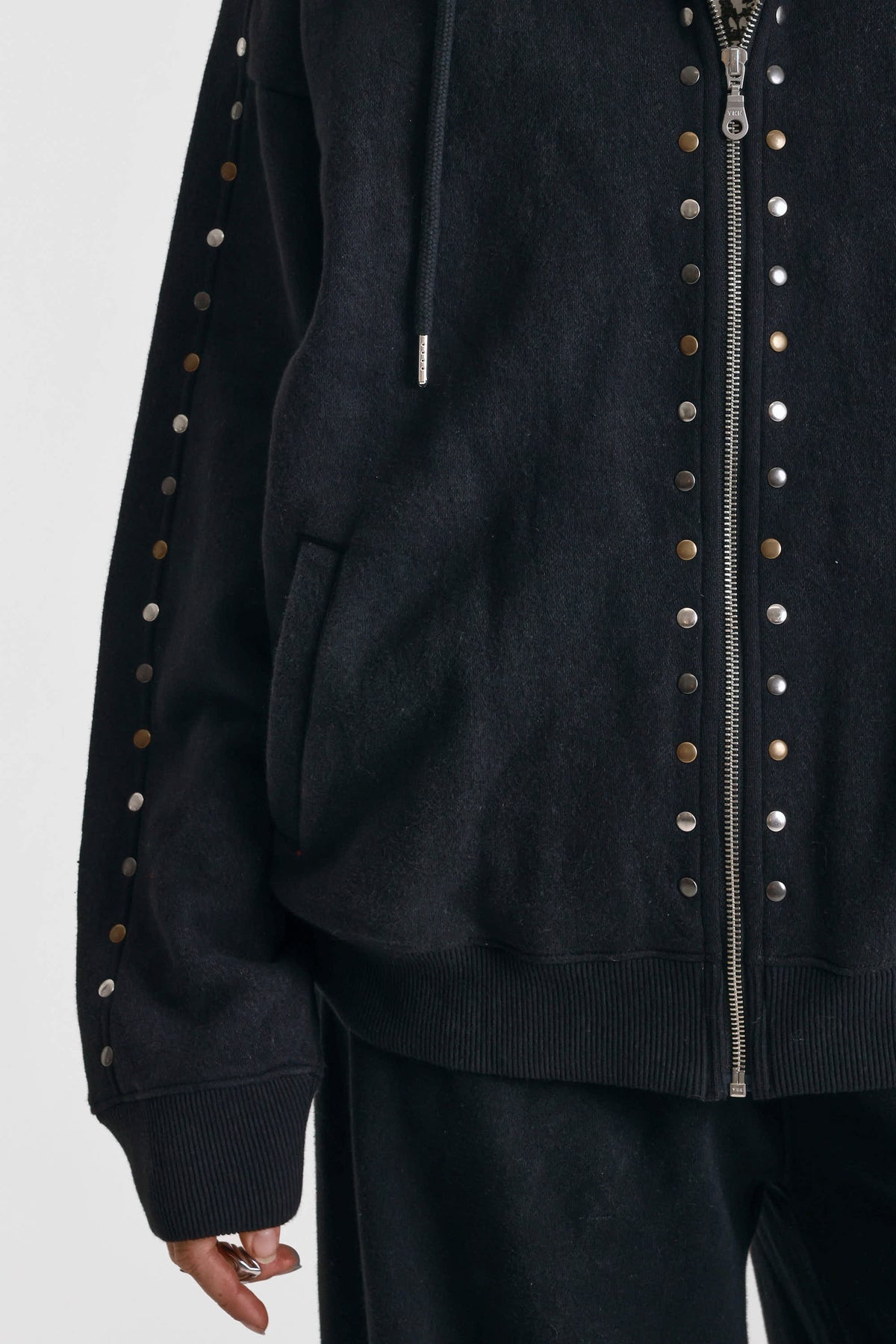 Washed black oversized zip up hoodie with mixed metal stud detail, worn by model