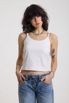 White strappy cami top with tie straps, cowl back and silver O rings, worn by model