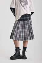 Black and white mixed check midi skirt with silver piercing hardware, worn by model