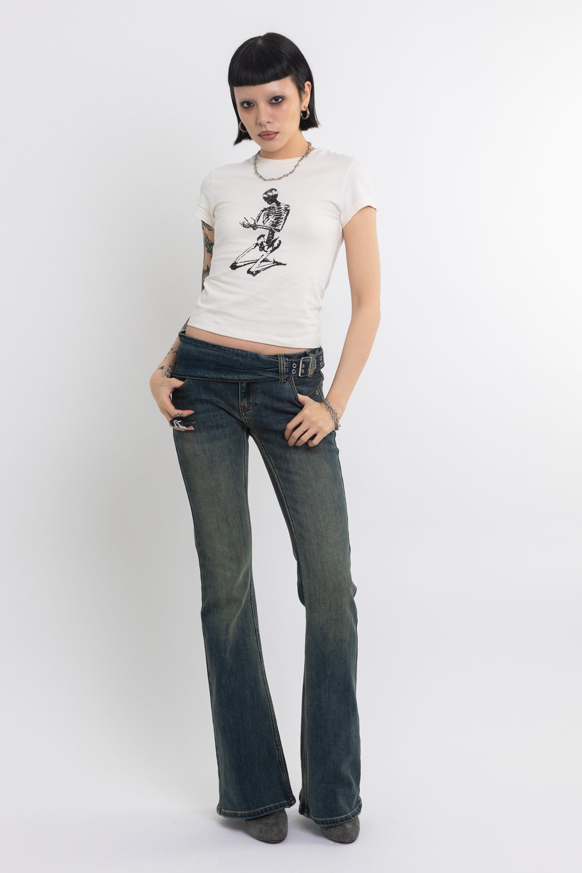 Off white baby t-shirt with praying skeleton graphic print, worn by model