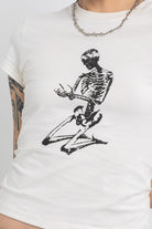 Off white baby t-shirt with praying skeleton graphic print, worn by model