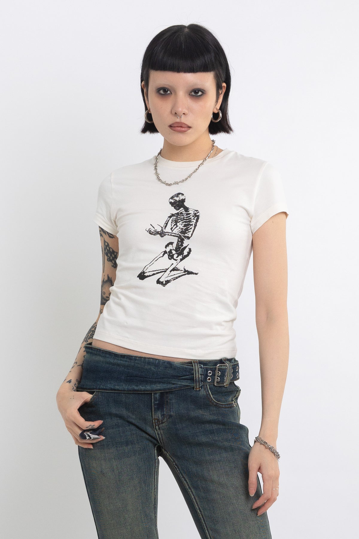 Off white baby t-shirt with praying skeleton graphic print, worn by model
