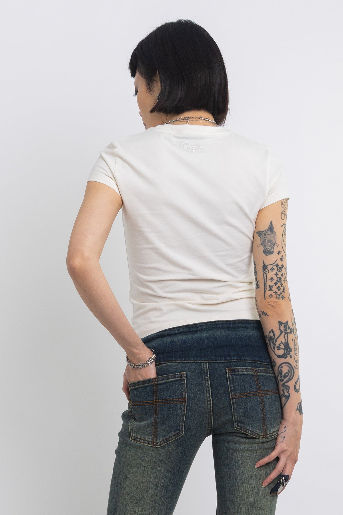 Off white baby t-shirt with praying skeleton graphic print, worn by model