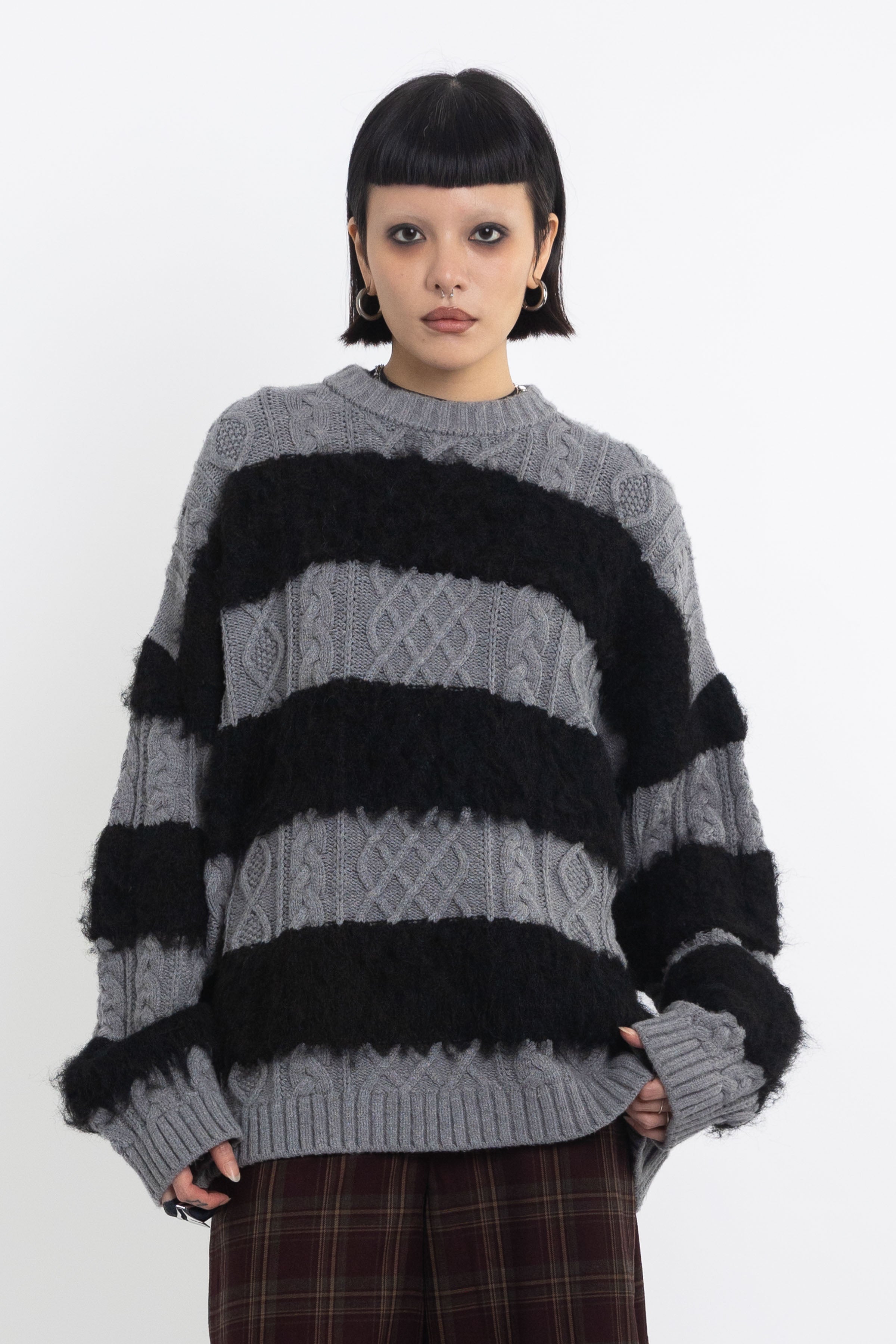 Black and grey mixed cable knit oversized jumper, worn by model