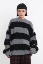 Black and grey mixed cable knit oversized jumper, worn by model