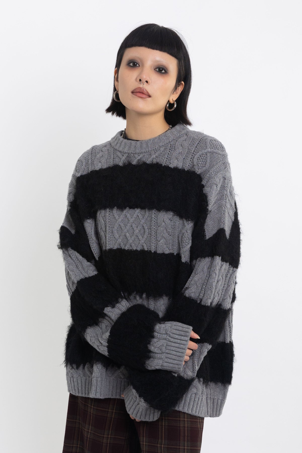 Black and grey mixed cable knit oversized jumper, worn by model