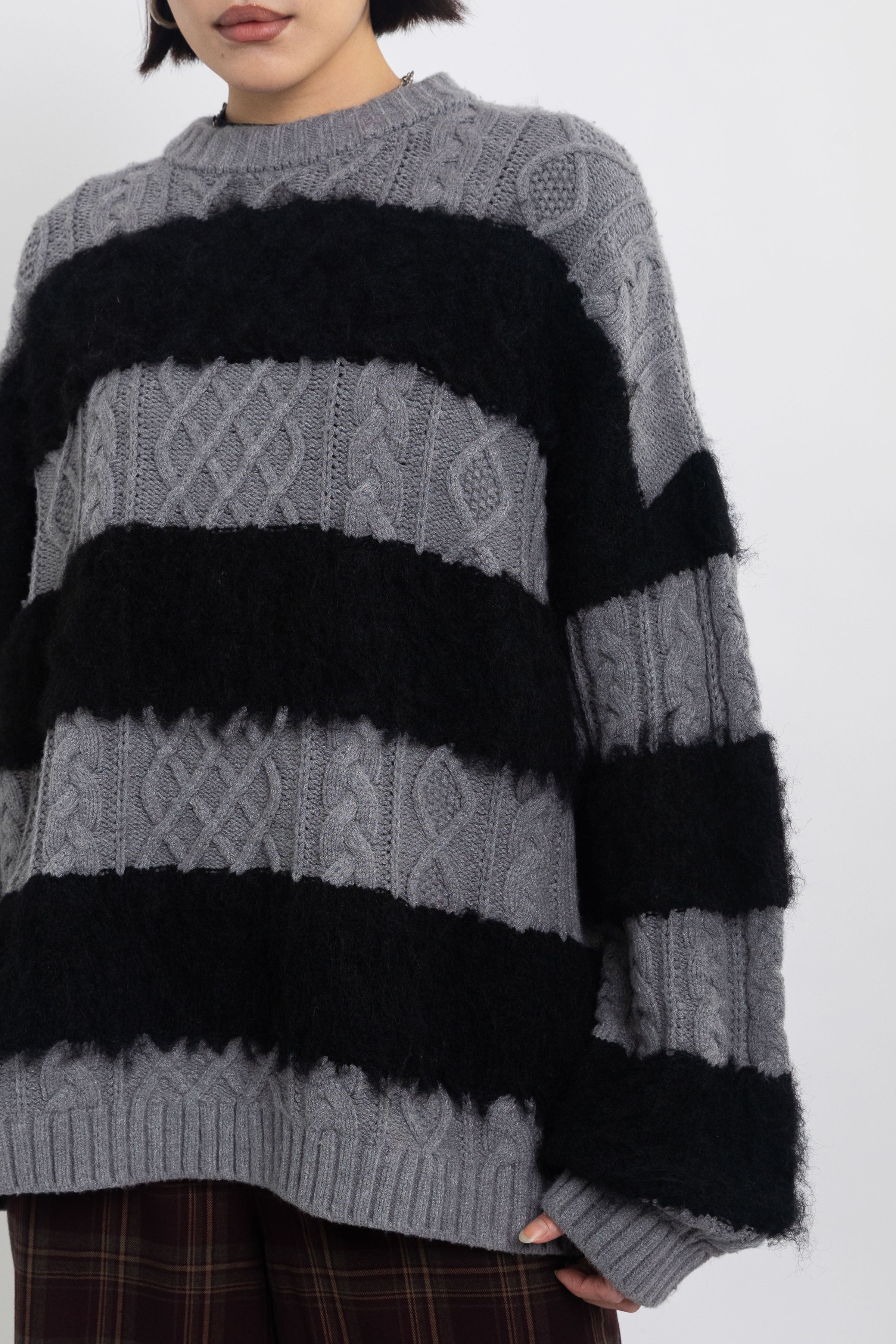 Black and grey mixed cable knit oversized jumper, worn by model