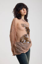 Dusty pink oversized sheer open knit jumper with deer graphic, worn by model