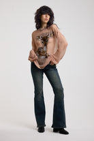 Dusty pink oversized sheer open knit jumper with deer graphic, worn by model