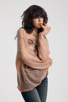 Dusty pink oversized sheer open knit jumper with deer graphic, worn by model
