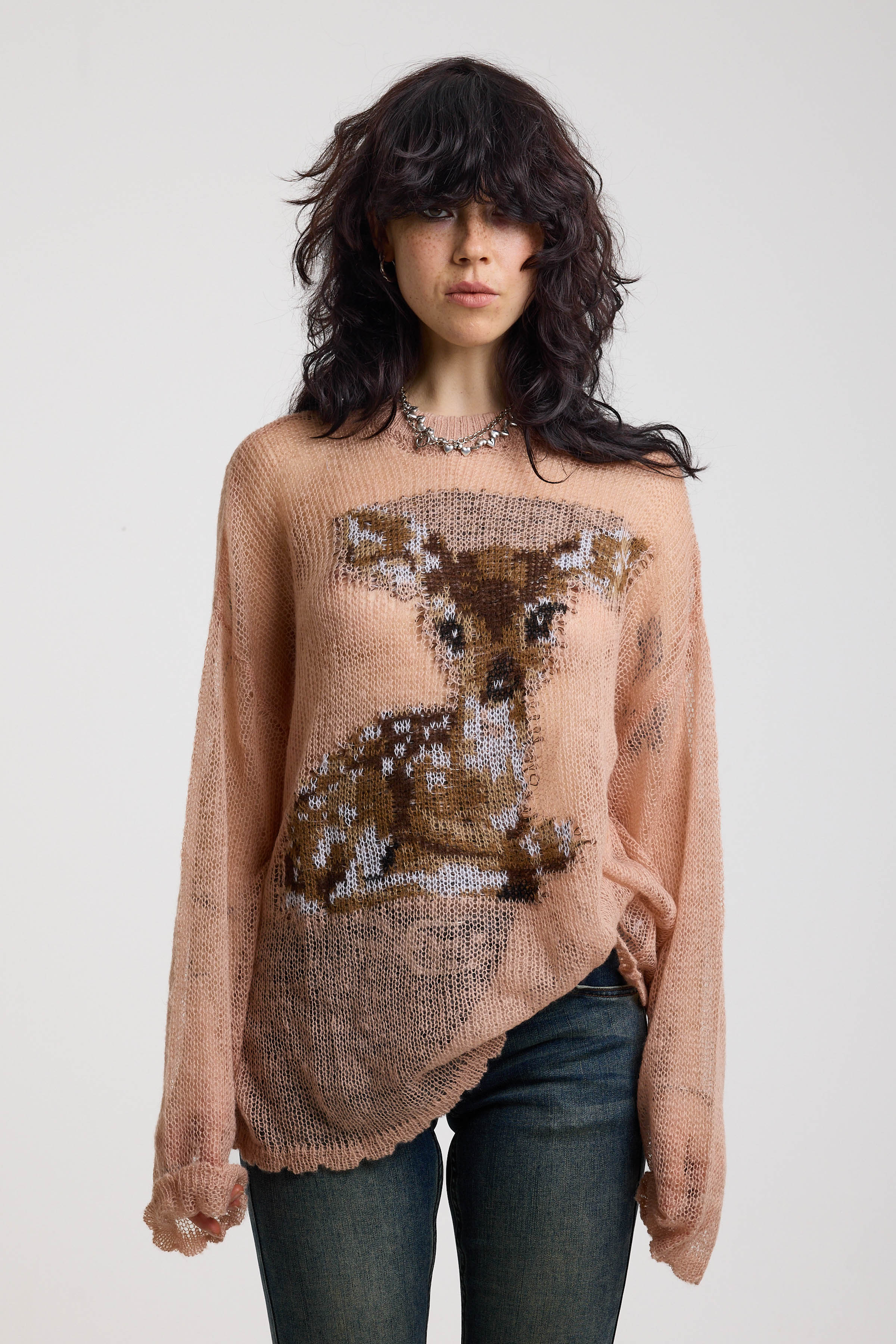 Dusty pink oversized sheer open knit jumper with deer graphic, worn by model